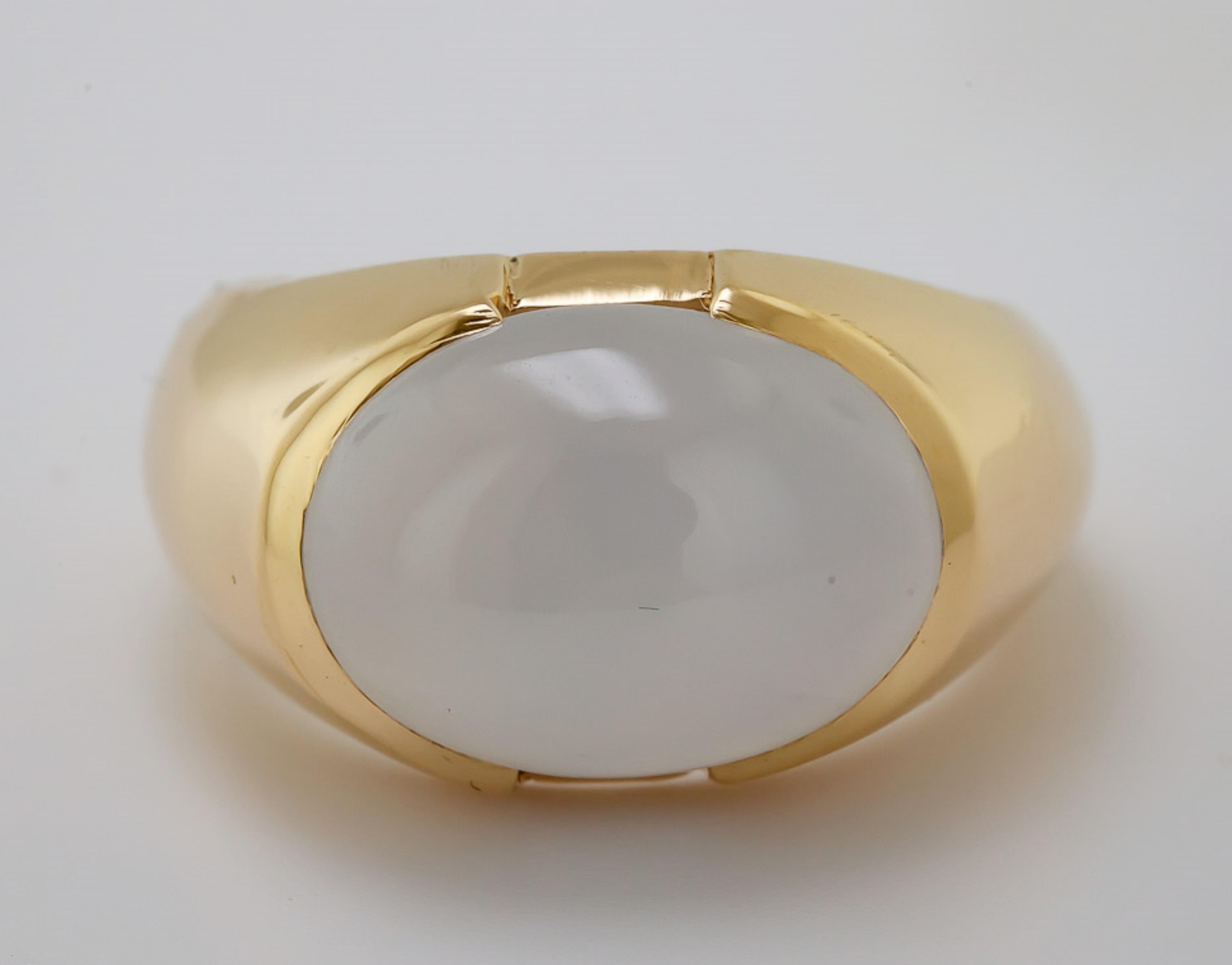 Featuring one natural, white, translucent, oval double cabochon jadeite jade, 19.9 X 10.55 X 6.00 mm, accompanied by a GIA Report, stating No indication of impregnation, bezel set in an 18k yellow gold mounting, measuring approximately 12 mm to 3.5