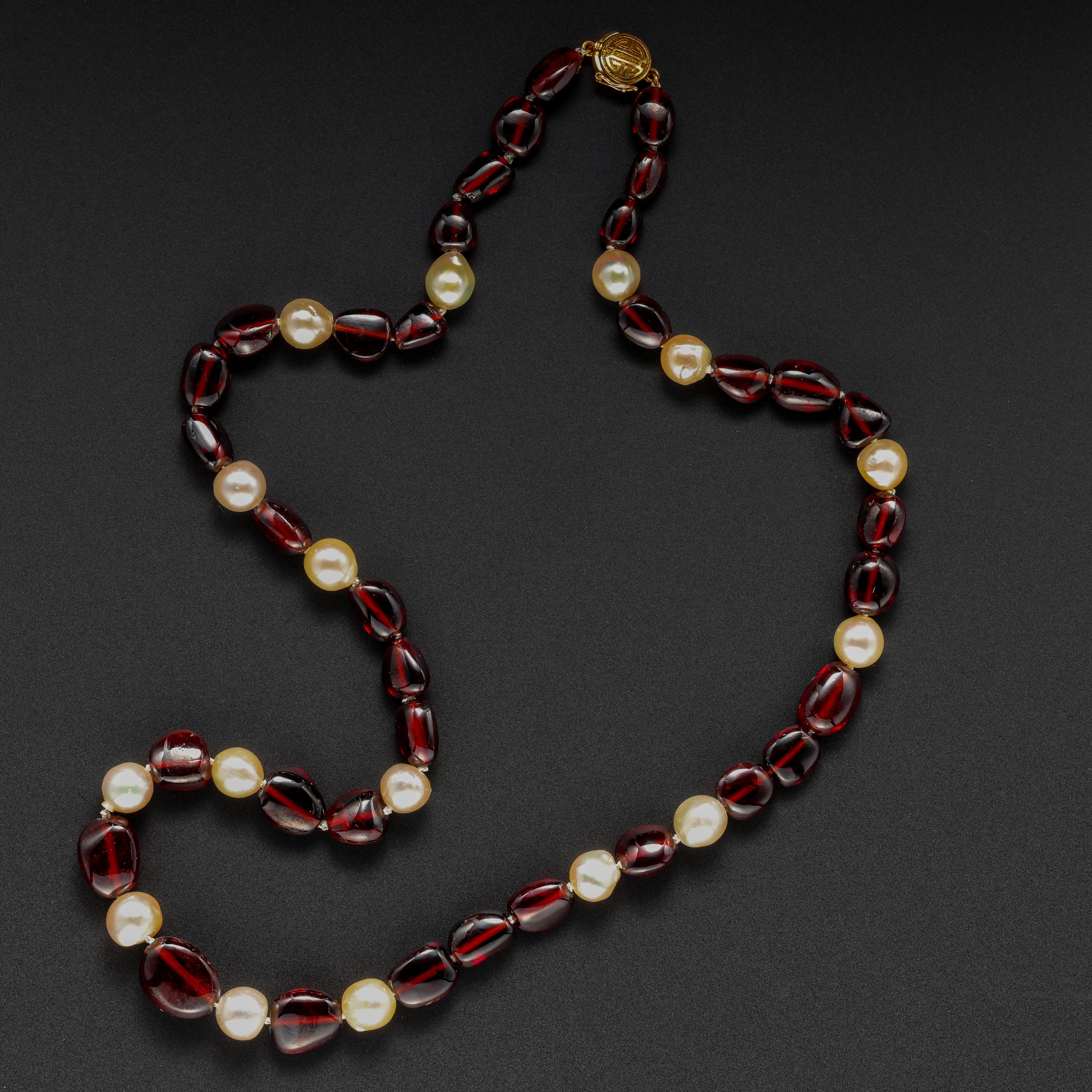 This vintage pearl and garnet necklace by Gump's of San Francisco features tumbled and polished garnet beads the color of  Cabernet Sauvignon, interspersed with luminous, lustrous cultured freshwater pearls, almost certainly from Japanese waters.