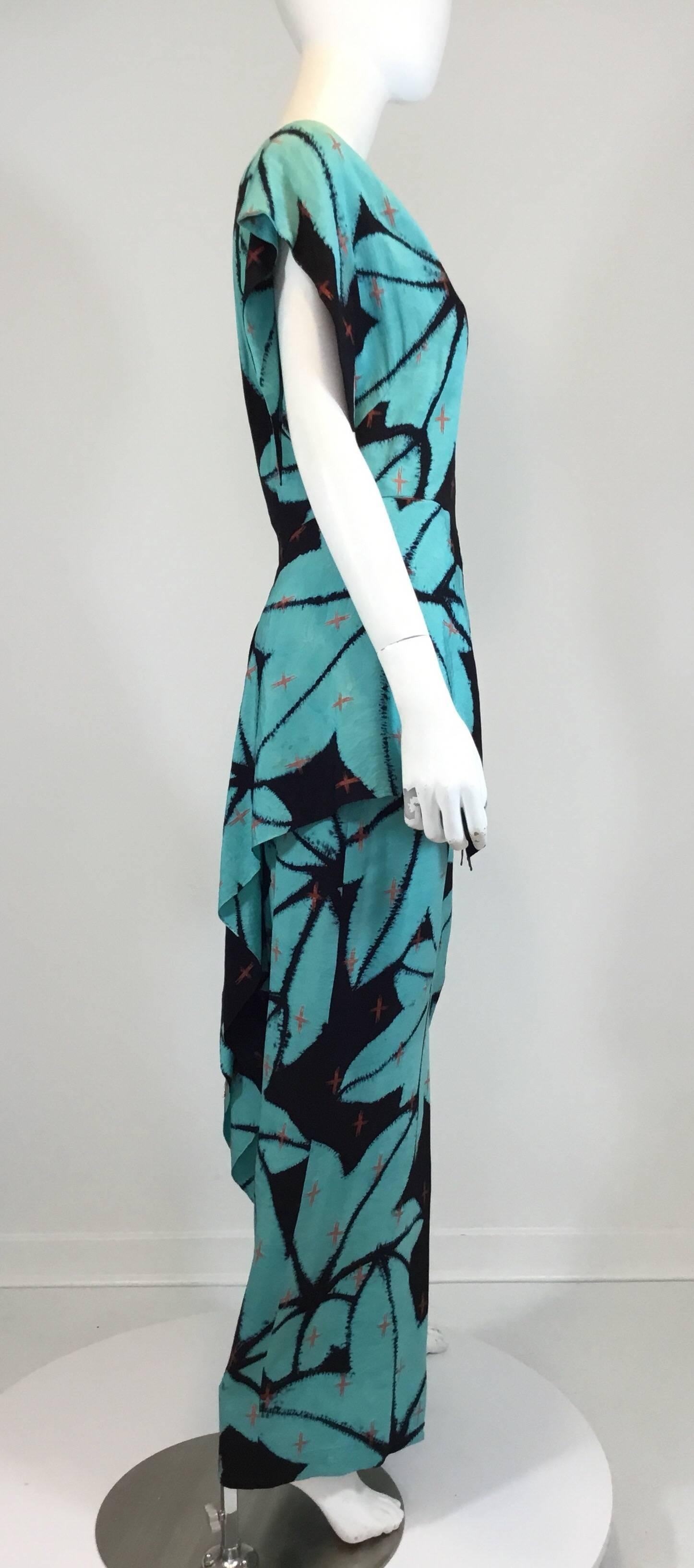 Gump's vintage 1930s dress features a turquoise and black print throughout with a V-neckline and an asymmetric peplum waist. From the estate of Mrs. Gump. Some age spotting and minor color fade, please see photos. Cleaned and very wearable. Labeled