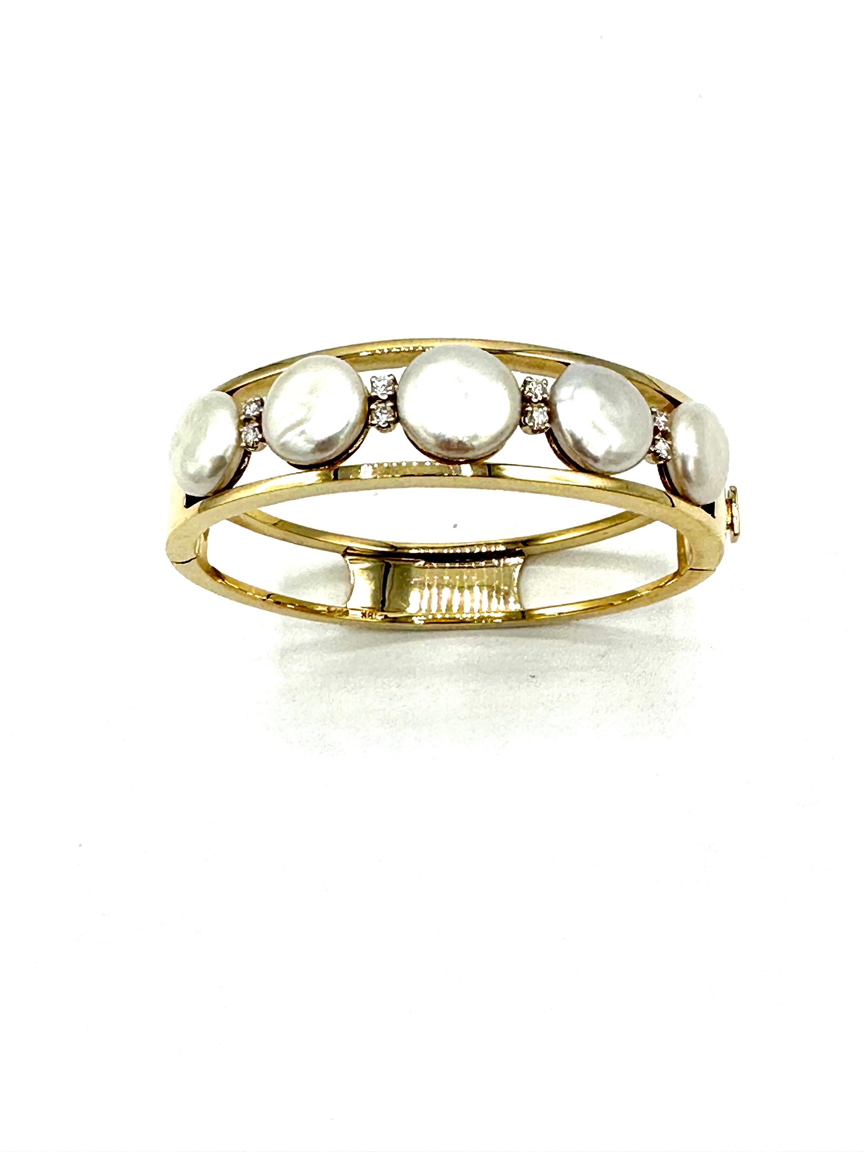 The bracelet that goes with everything!  This bangle designed by Gumps, features five coin Pearls set between two rows of 18K yellow gold, with two Diamonds in between each Pearl.  The eight round brilliant Diamonds have a total weight of 0.32