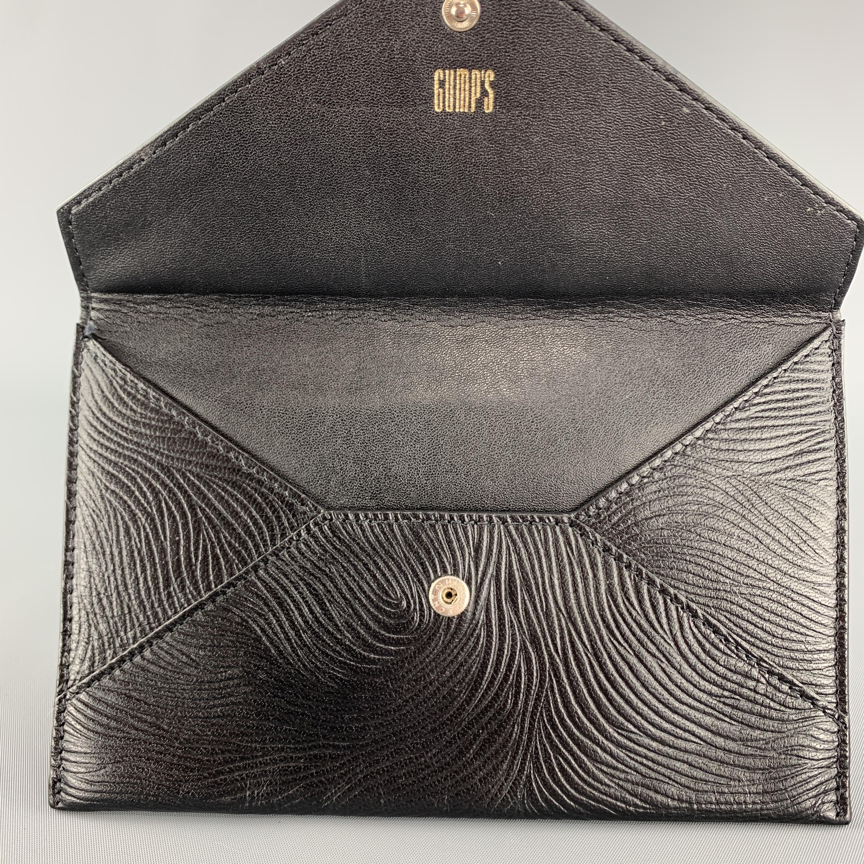 GUMP'S envelope wallet case comes in black embossed pattern leather with a snap closure. 

Excellent Pre-Owned Condition.

7.25 X 4.65 in.