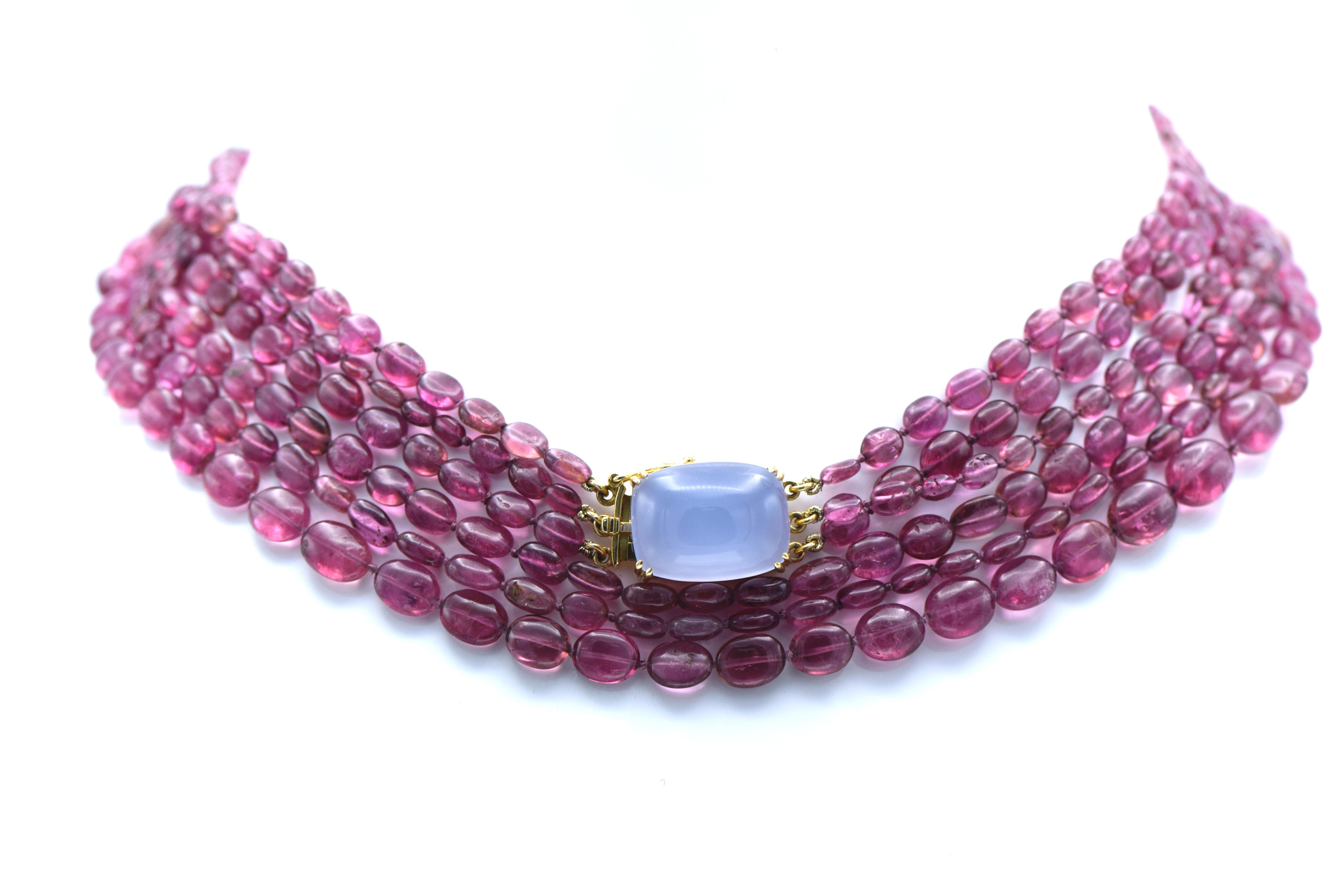 A necklace consisting of 3 strands of pink Tourmaline oval beads ranging from 9.5 x 8.5mm to 6.0 x 4.0mm measuring approximately 36