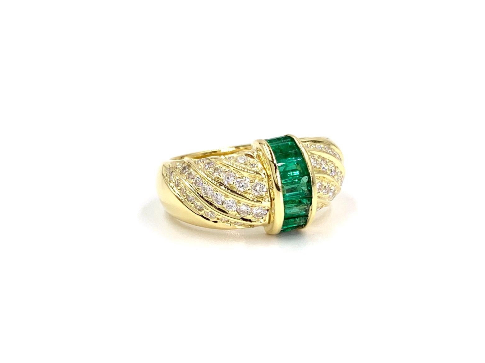 A high polished 18 karat yellow gold modern emerald and diamond ring created by Gumuchian. This slightly domed ring features 7 high quality channel set emerald cut green emeralds at .65 carats total weight flanked by .59 carats of bead set round