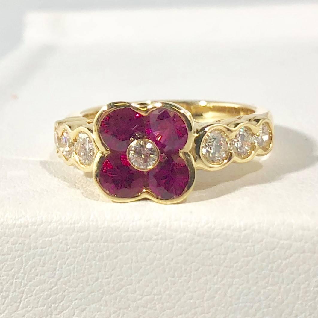 Gumuchian 18 karat Yellow gold, diamond and ruby flower cocktail ring. This designer piece by Gumuchian  is created in 18 karat yellow gold weighing 6.2 grams/ 4dwt. There are 4  round rubies  equaling 1.00 carat total weight, bright red color.