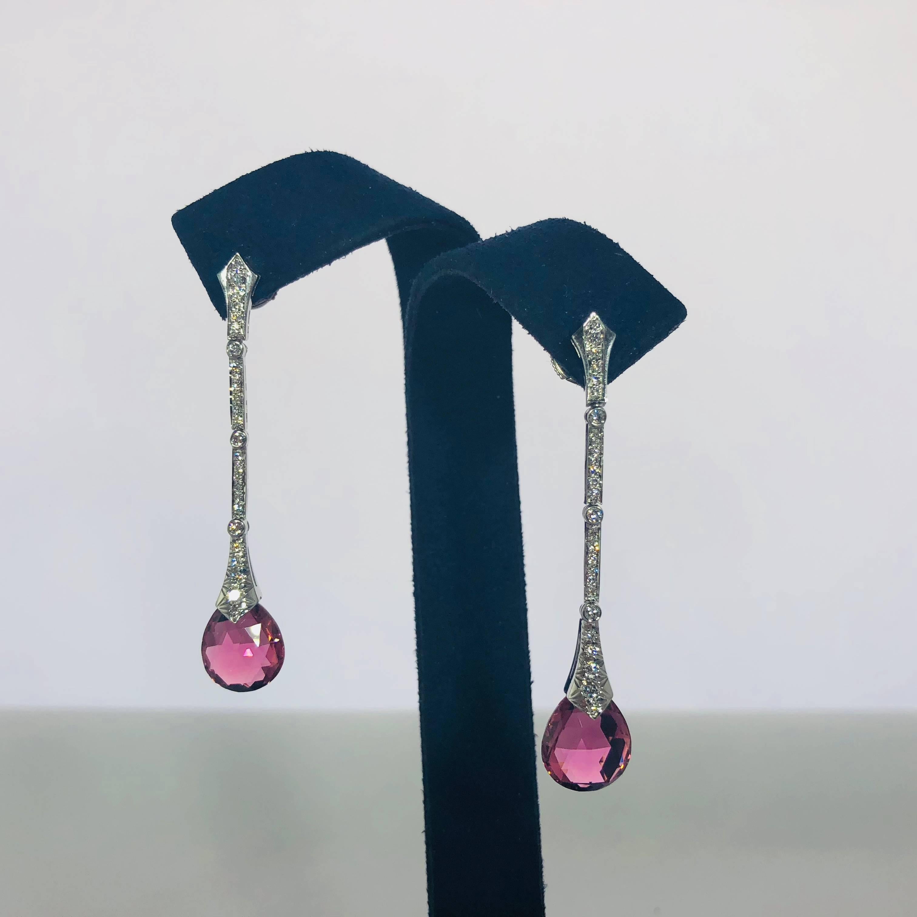 Platinum diamond and pink tourmaline stiletto earrings by Gumuchian, 2- fancy pear shaped Pink tourmalines equaling 6.45 carat total weight, bright raspberry color, 52- full cut round diamonds equaling .37 carat total weight, average color F-G,