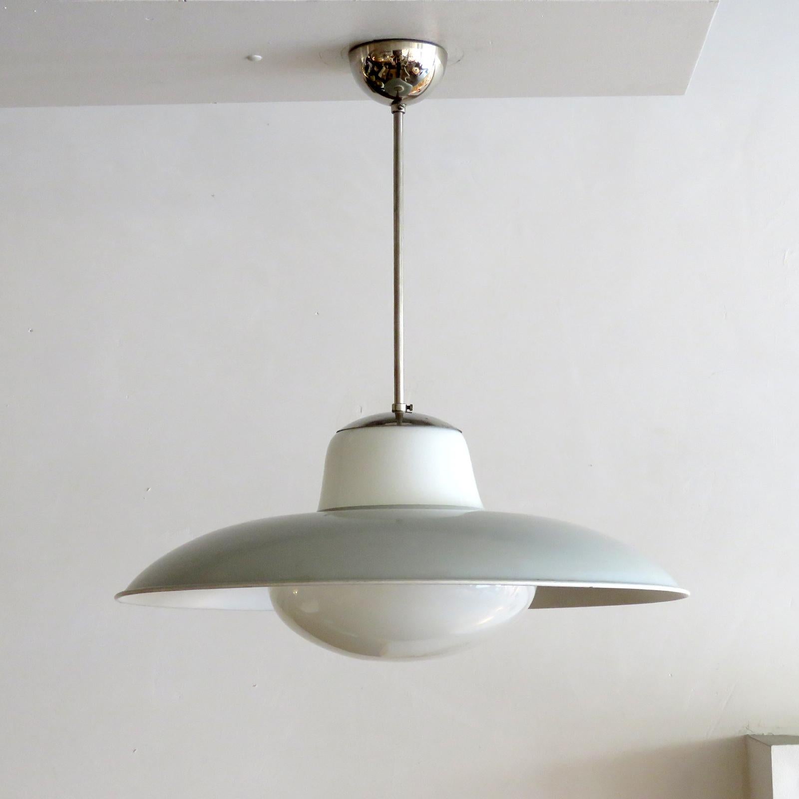 Wonderful '1059' pendant lights by Gunilla Jung for Stockmann-Orno in nickel-plated brass with white opaline shades under a white metal reflector, manufacturer mark, wired for US standards, one E27 socket, max. wattage 75w, bulbs provided as a one