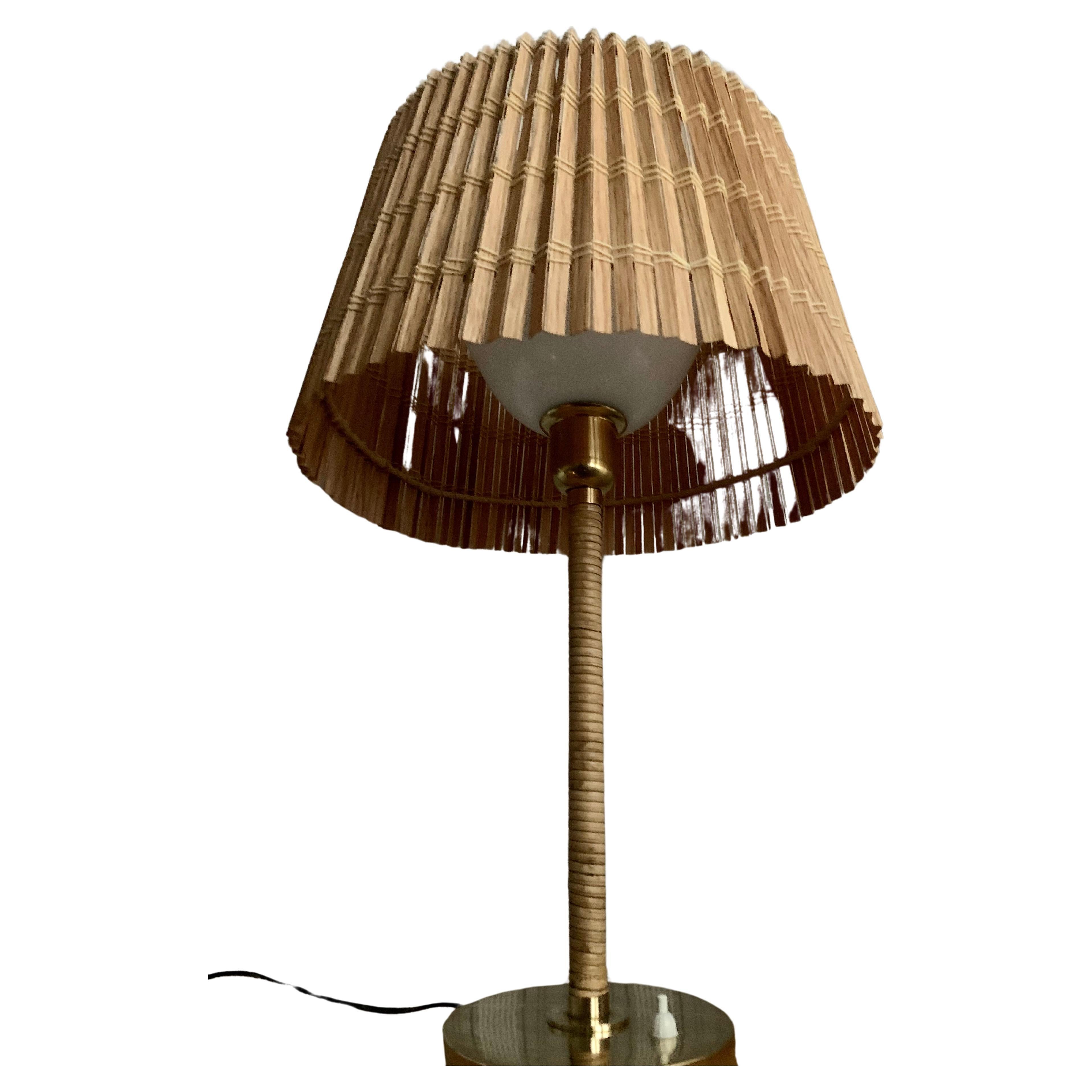 really impressive Finnish design lamp, materials brass and rattan. I shaded a spectacular wood slat. (aspen). This lamp is rare because Gunilla Jung worked only for a short time as a designer at ORNO