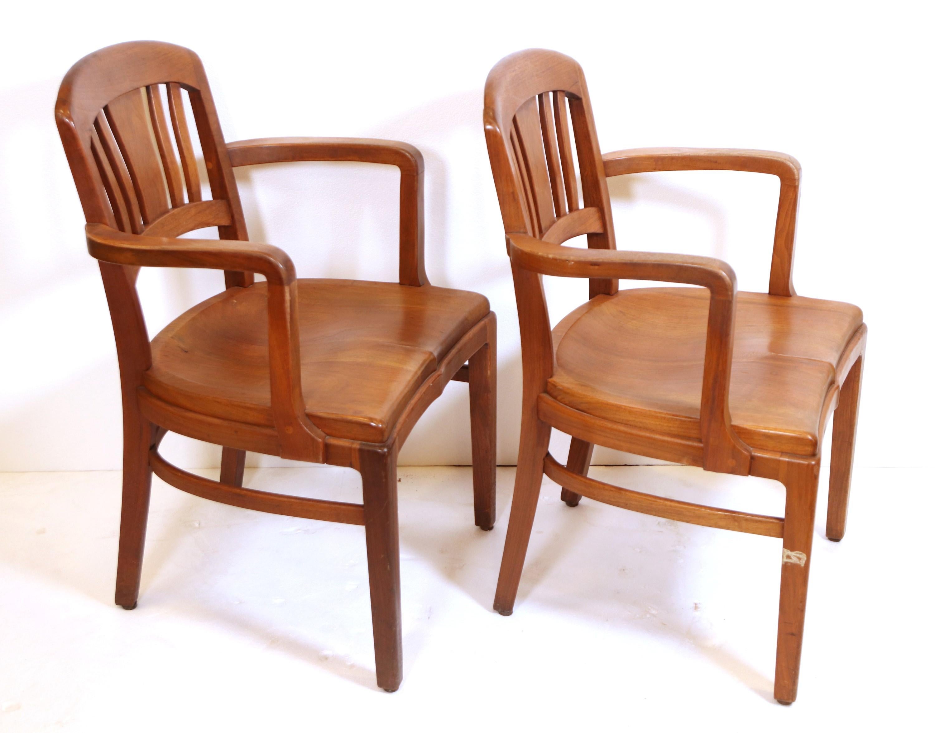 Mid-Century Modern walnut office Banker's style chair made by Gunlocke.  They are solid wood with armrest and have an Art Deco style back. Priced as a pair. Please note, this item is located in one of our NYC locations.