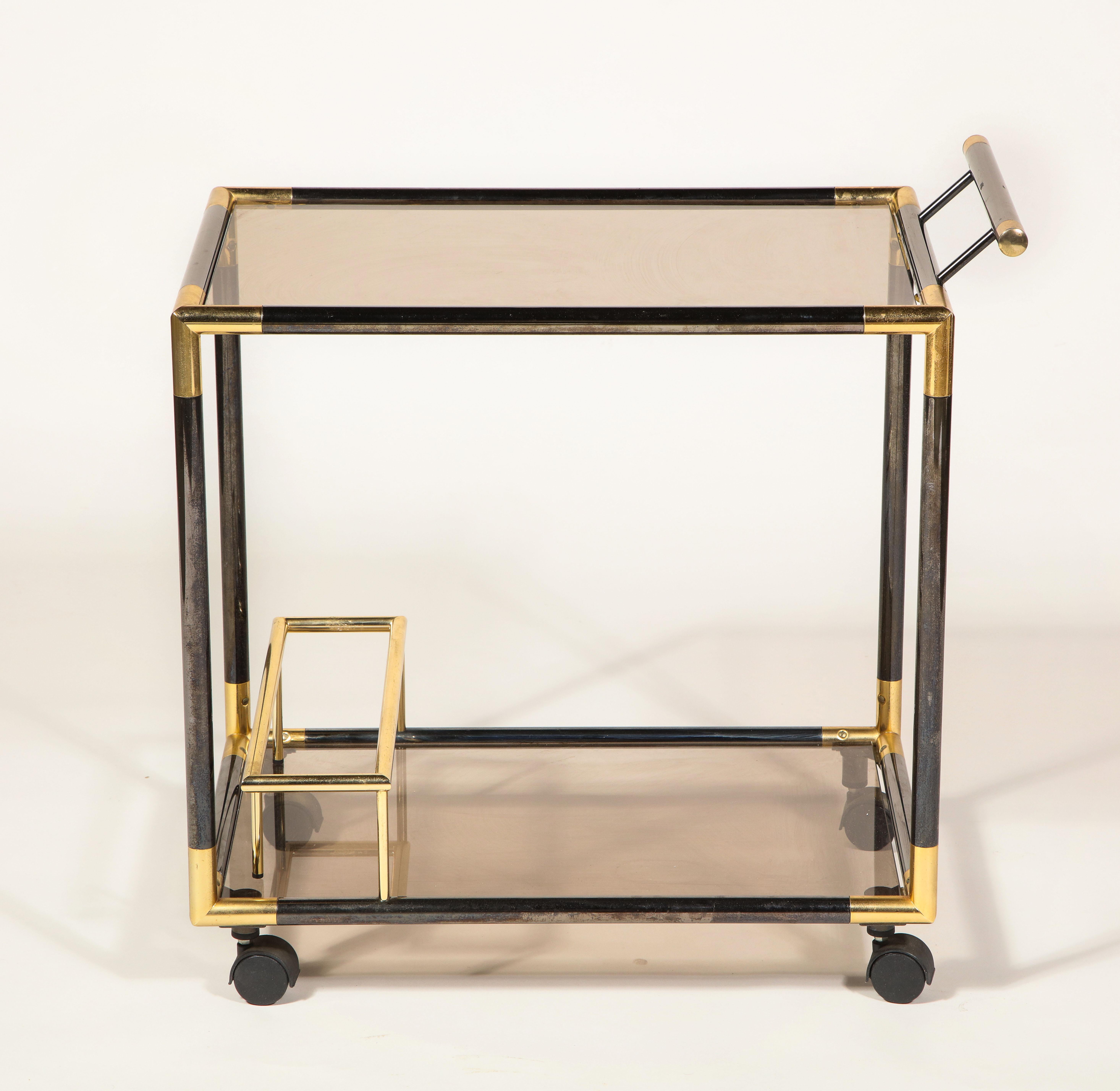 Gunmetal and brass bar cart, France, 1980s.

Chic bar cart with smoked glass and gunmetal and brass detailing throughout. Although this was thought to be from Italy it is imported from France.