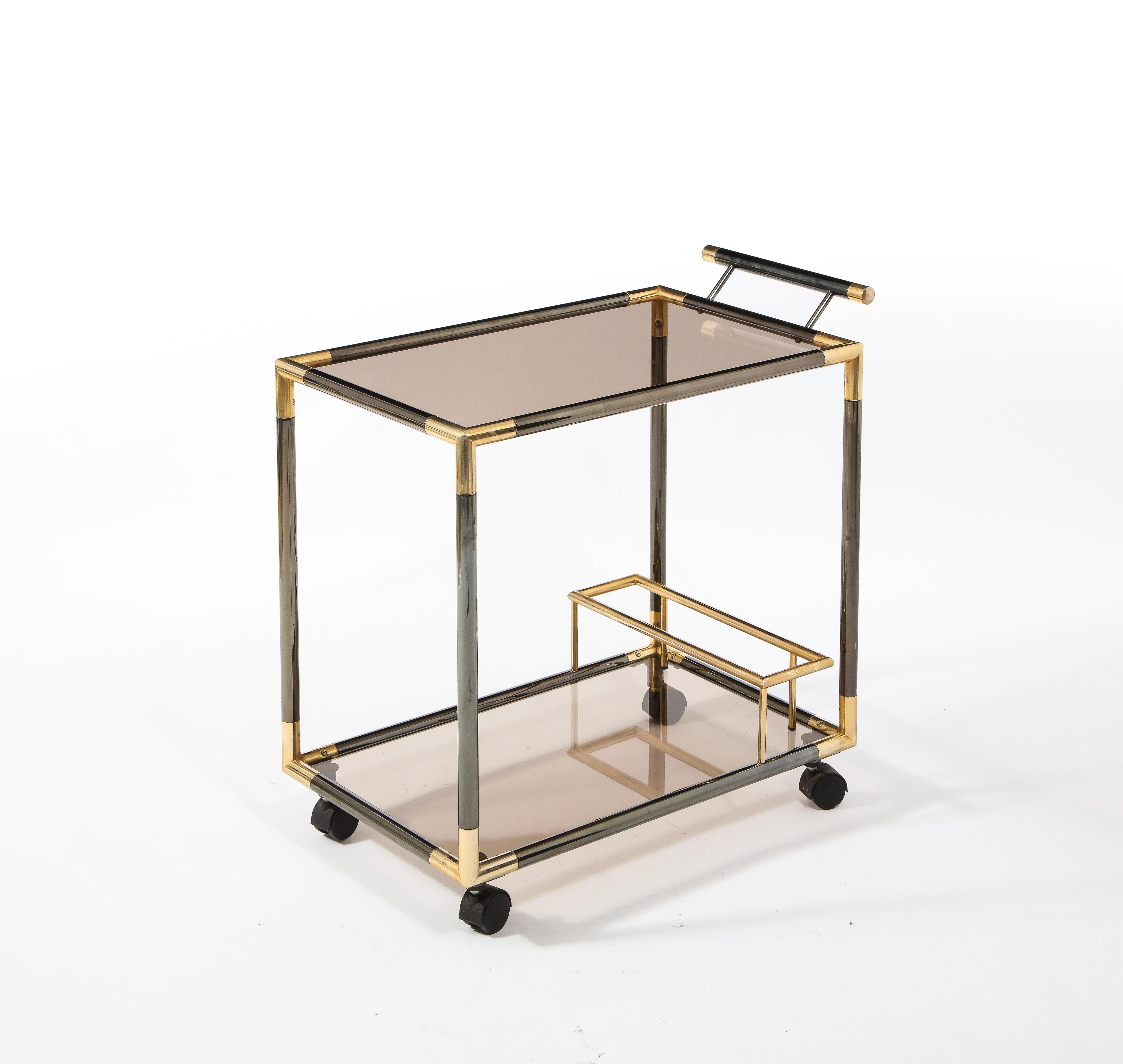 A two-tone brass bar cart with smoked glass shelves.
