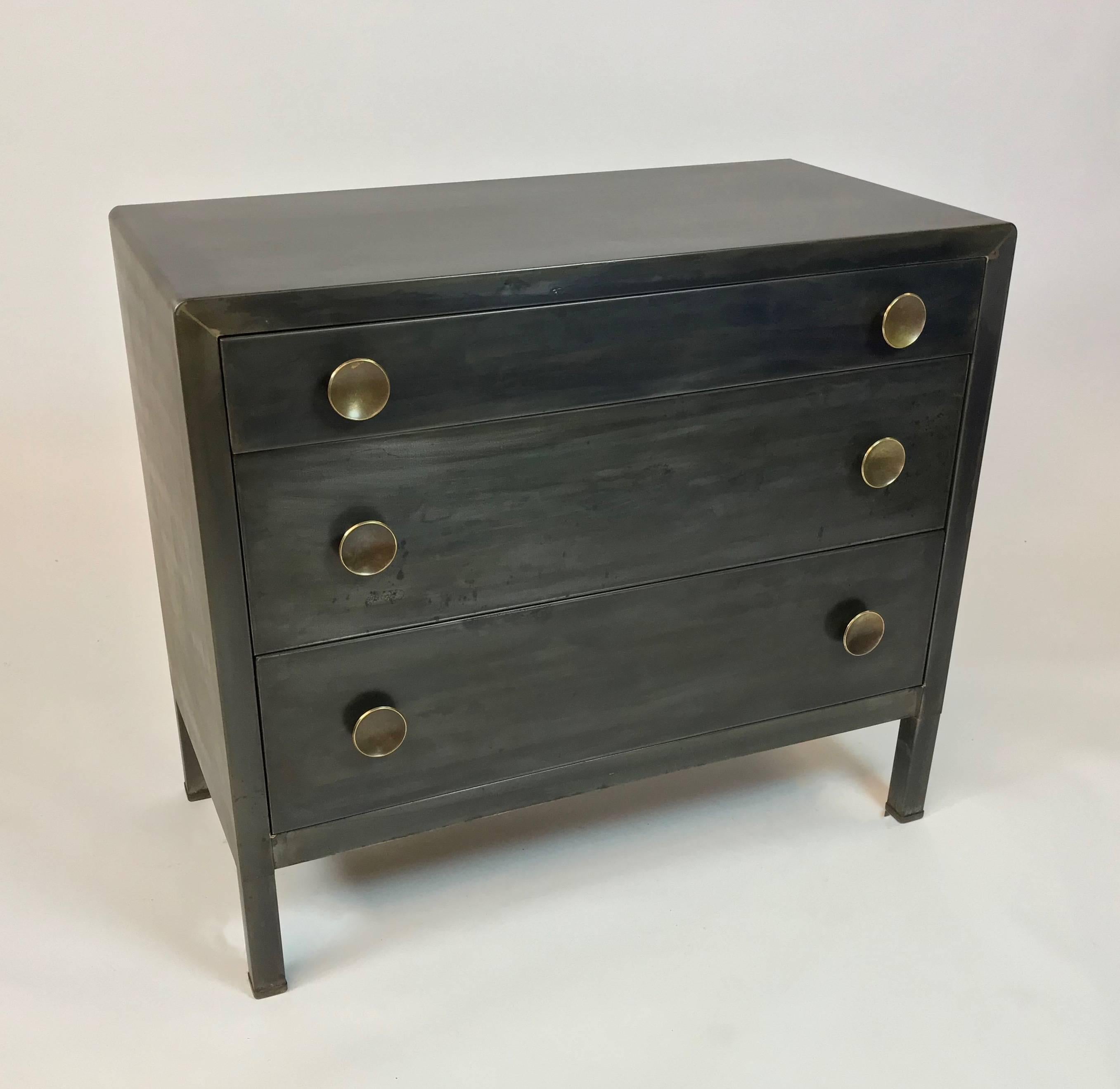 Machine-age, brushed steel, three-drawer dresser designed by Norman Bel Geddes for Simmons Company Furniture features a custom gunmetal finish with contrasting round brass knobs. The bottom drawers are 9 inches height and the top drawer is 4.5