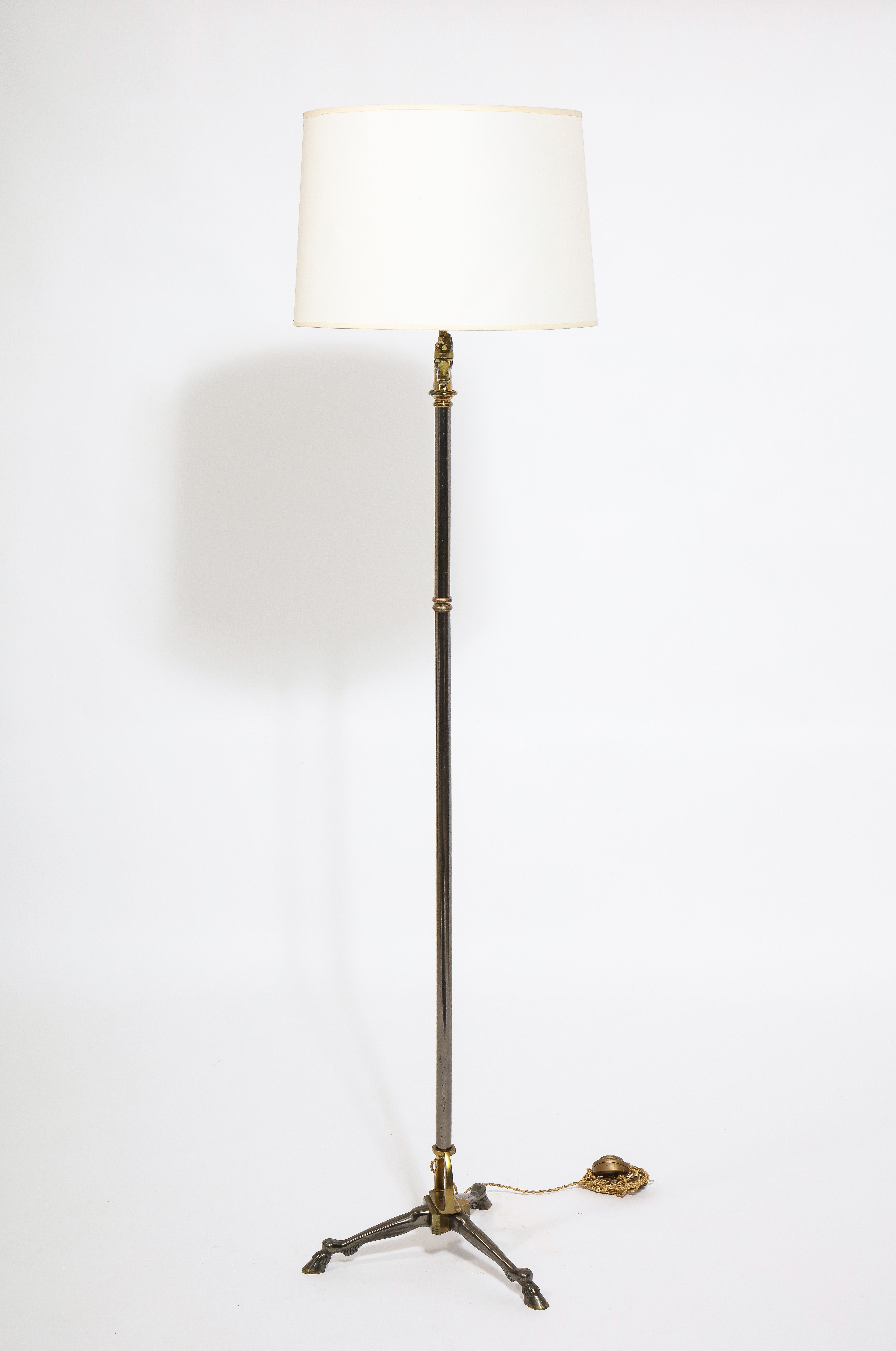 Exceptional neo-classical tripod floor lamp by Maison Jansen. Equestrian themed bronze and gunmetal finish. Rare piece. Wired for use in the US. 
Pole is height adjustable from 5.25ft to 6.9ft.
The lamp will sell without the shade.
 