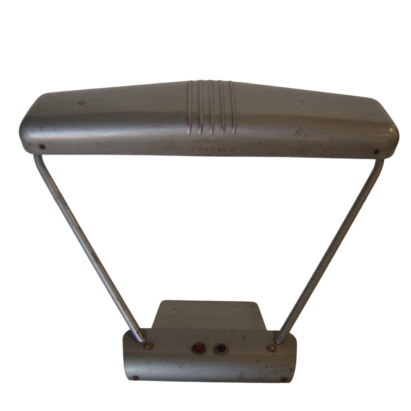 1950s gunmetal grey fluorescent machine age tanker desk lamp with lots of character, perfect on a vintage desk. Push-button on and off switch. Measures: 20