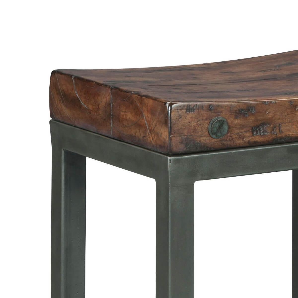A Byron finish bar stool, the shaped plank seat with bold brass bolts, on a gunmetal iron base.

Dimensions: 18