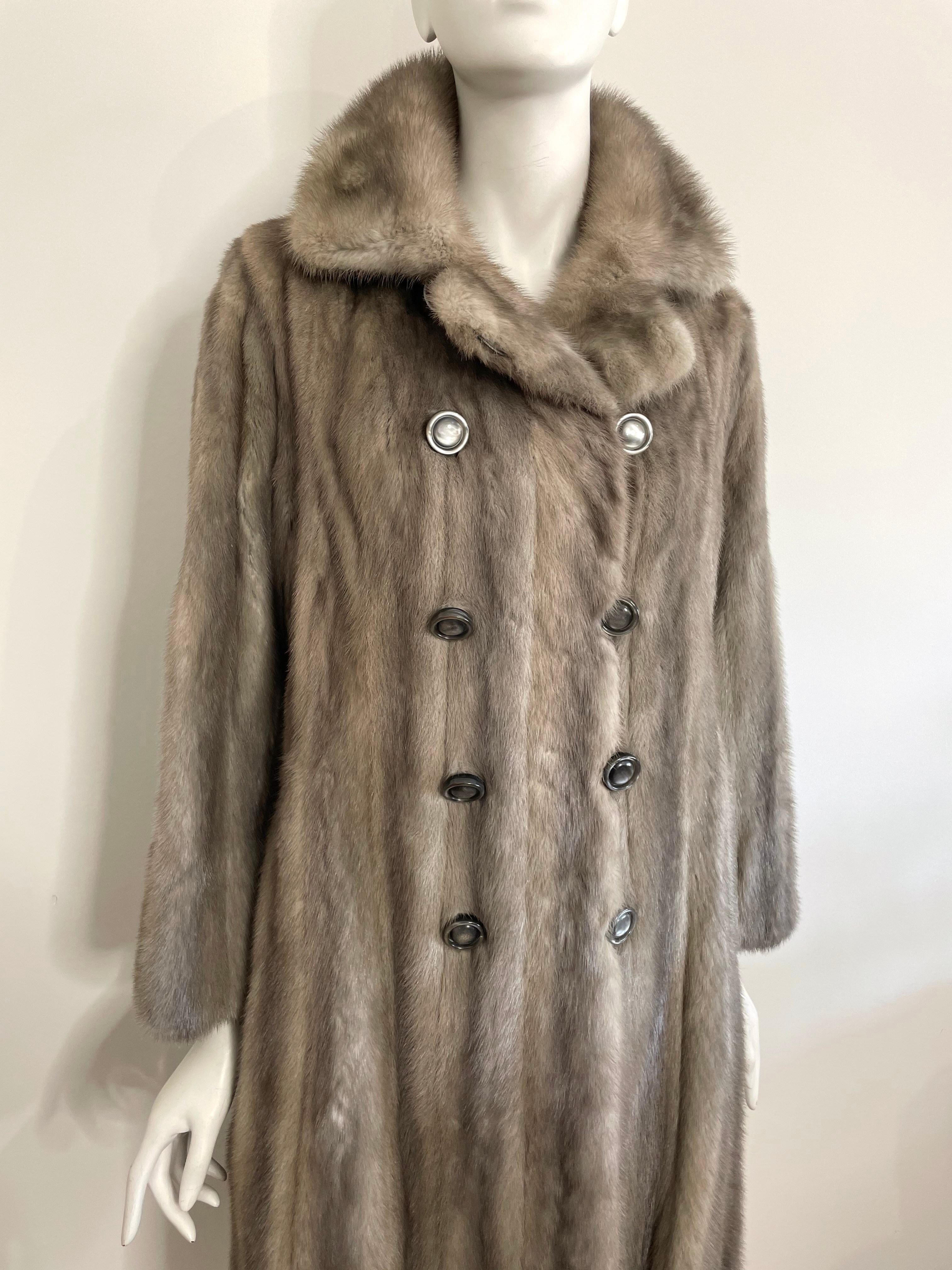 Stunning Emba Natural Gunmetal Mink. Soft and supple and kept in wonderful condition. Double Breasted, Faux back belt accent. 2 Slit front pockets. Amazing lining on this one with a French Hem. Nice Detailing.  Photographed on a dress form that is a