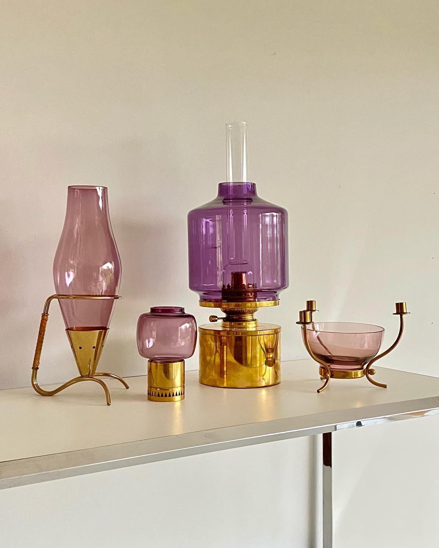 Gunnar Ander candle stick by Ystad Metal. Nice candleholder with purple transparent glass. The candle holder is marked with 'Made in Sweden'. The price is for one candleholder.
