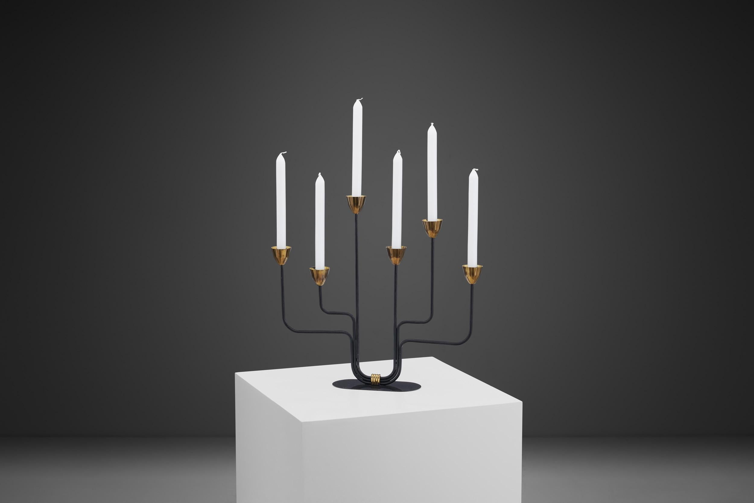 Gunnar Ander was an industrial designer and architect, and one of the brightest stars of 20th-century Swedish metal, wood, and glass design. His most well-known models are the innovative designs for Ystad Metall, such as this unique pair of candle