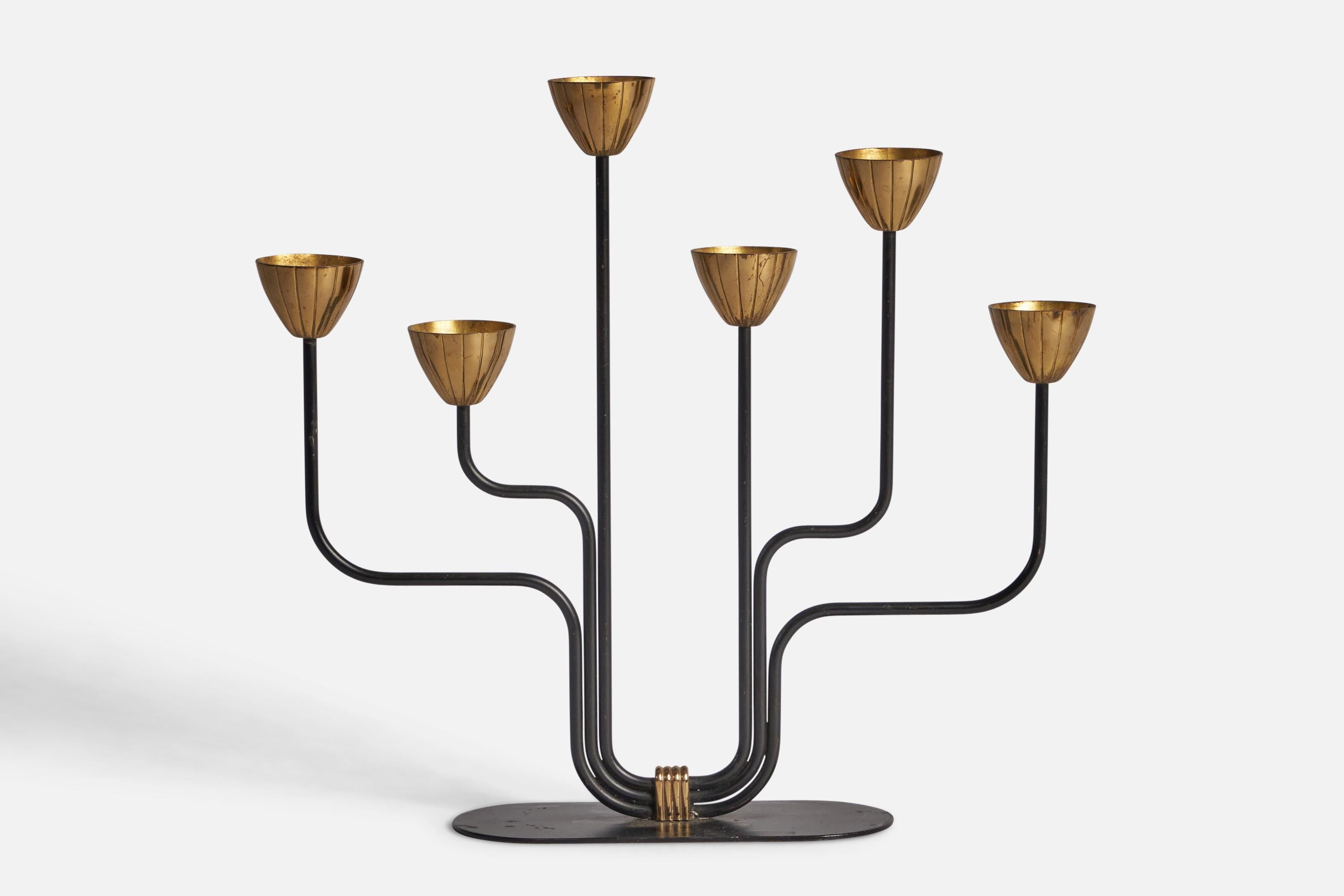 A brass and black-painted metal candelabra designed by Gunnar Ander and Produced by Ystad-Metall, Sweden, c. 1940s.

Holds 0.53” x 0.4” diameter candles