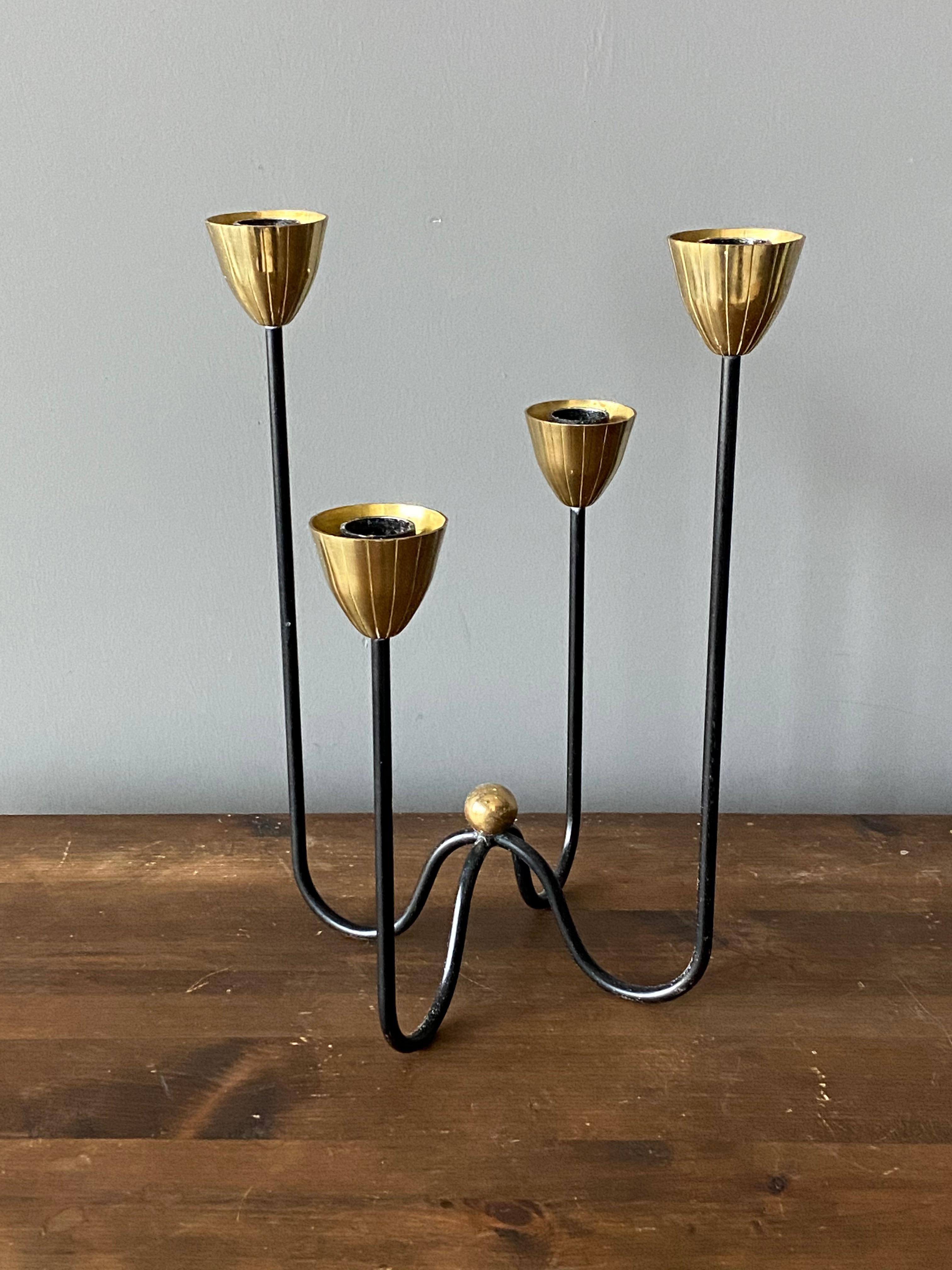 A pair of organic candelabra or candleholders, designed by Gunnar Ander for Ystad Metall, Sweden, 1950s. In brass and lacquered steel. Stamped.

Other designers of the period include Piet Hein, Paavo Tynell, Josef Frank, and Jean Royere.

  