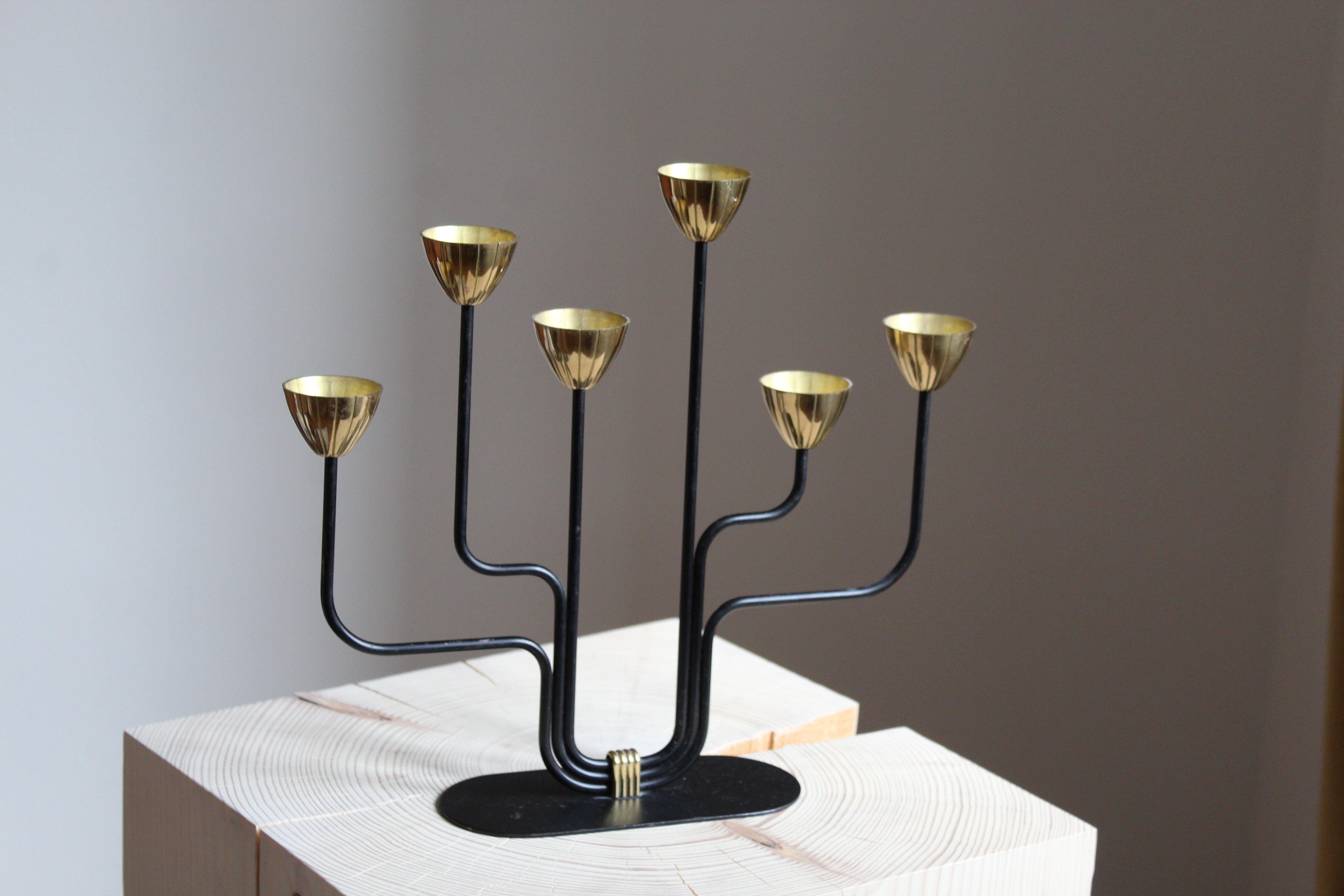 A candelabra, designed by Gunnar Ander for Ystad Metall, Sweden, 1950s. In brass and lacquered steel. Stamped. Smaller model for small candles.

Other designers of the period include Piet Hein, Paavo Tynell, Josef Frank, and Jean Royere.

 