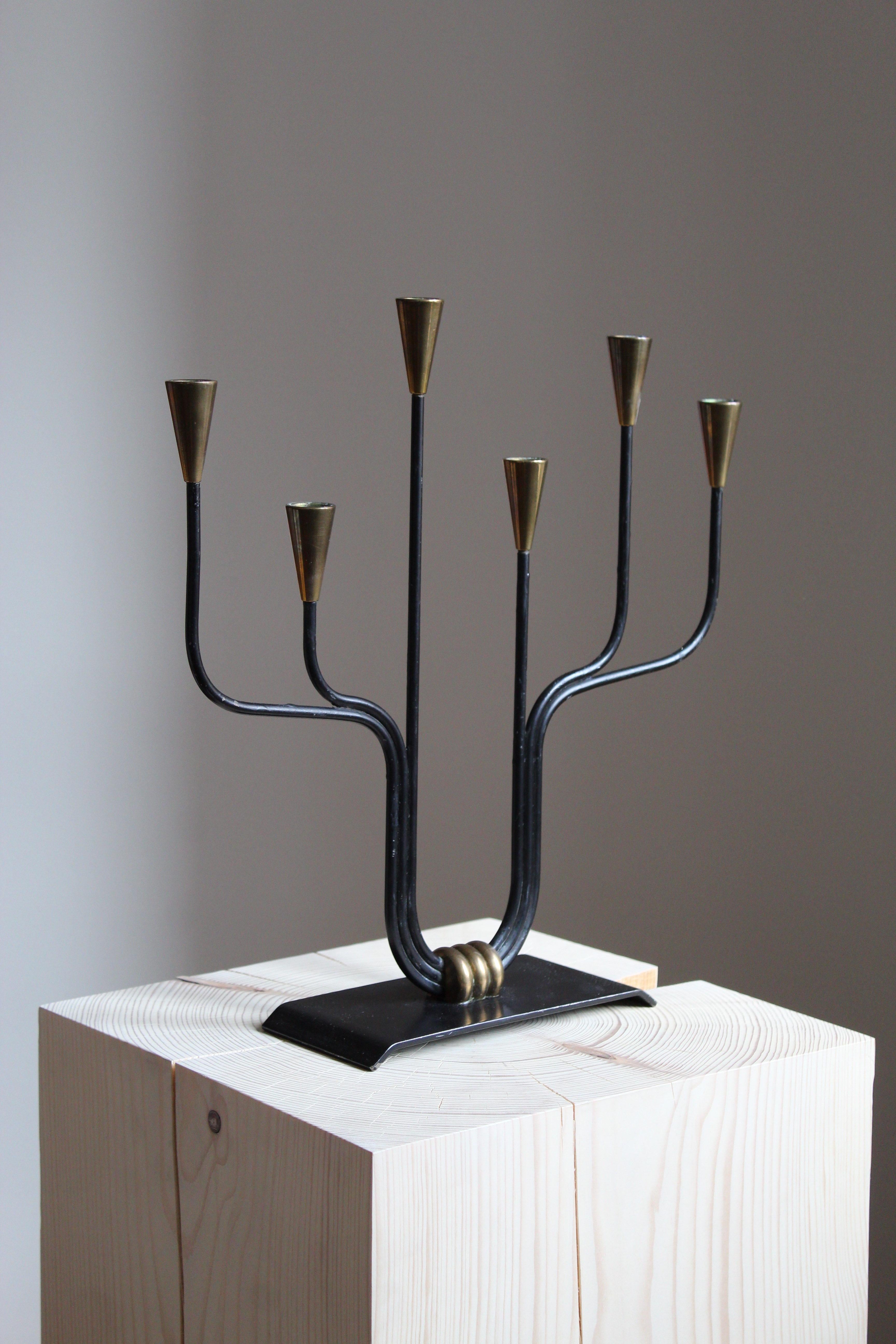 A candelabra, designed by Gunnar Ander for Ystad Metall, Sweden, 1950s. In brass and lacquered steel. 

Other designers of the period include Piet Hein, Paavo Tynell, Josef Frank, and Jean Royere.

 