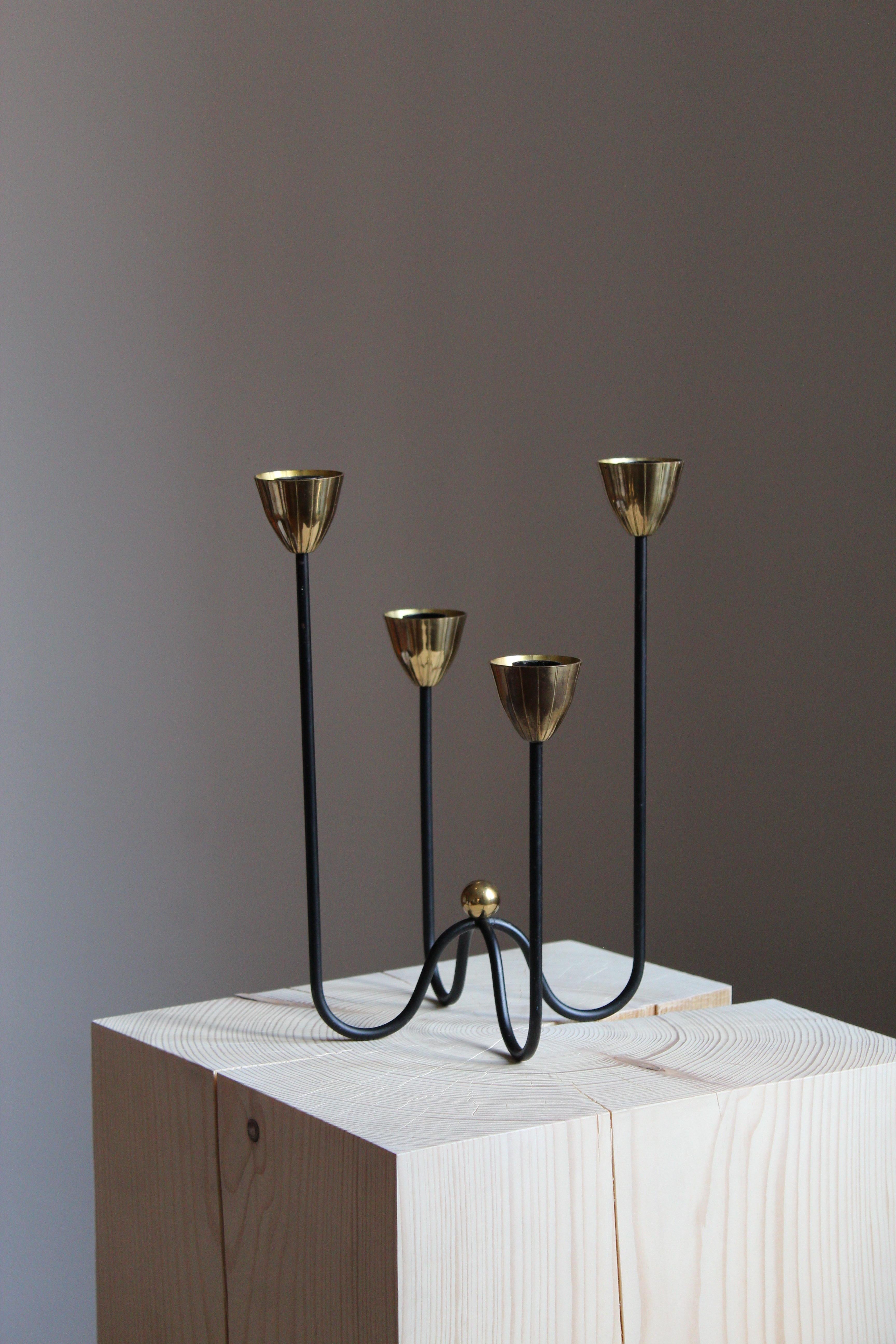A pair of organic candelabrum or candleholders, designed by Gunnar Ander for Ystad Metall, Sweden, 1950s. In brass and lacquered steel. Stamped.

Other designers of the period include Piet Hein, Paavo Tynell, Josef Frank, and Jean Royère.

  