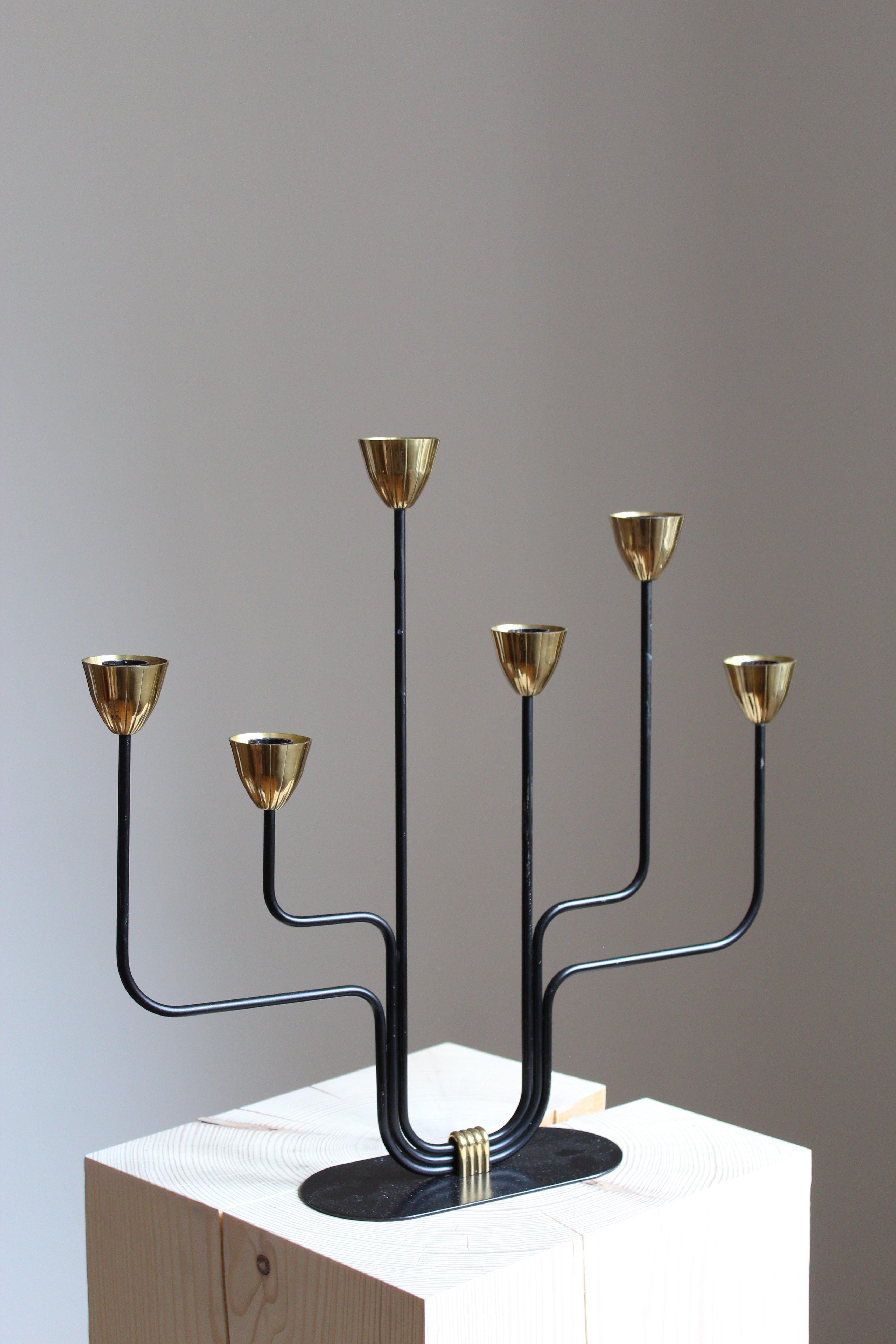 A sizable candelabra, designed by Gunnar Ander for Ystad Metall, Sweden, 1950s. In brass and lacquered steel. Stamped.

Other designers of the period include Piet Hein, Paavo Tynell, Josef Frank, and Jean Royere.

 
