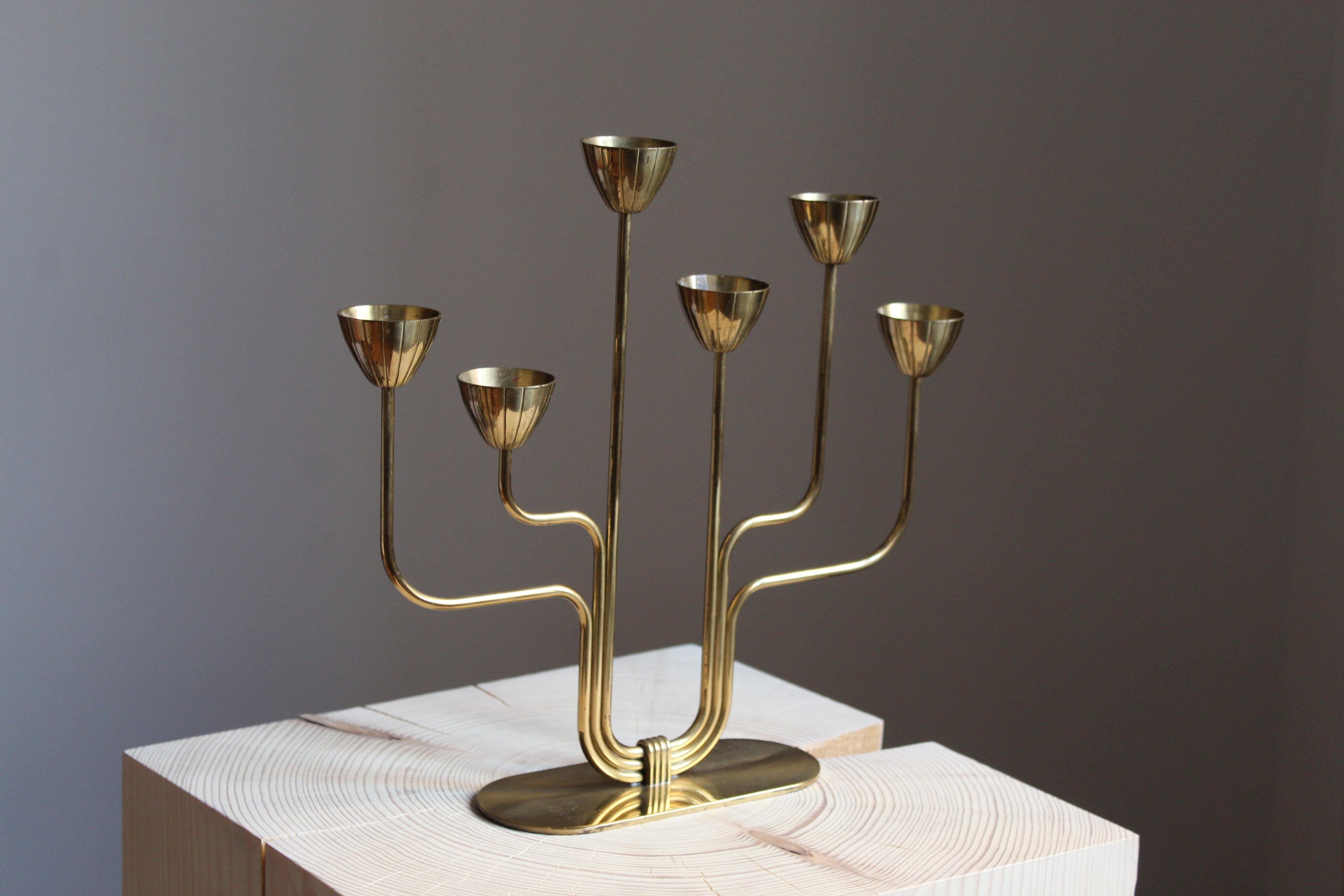 A candelabra, designed by Gunnar Ander for Ystad Metall, Sweden, 1950s. In brass and lacquered steel. Stamped. Smaller model for small candles.

Other designers of the period include Piet Hein, Paavo Tynell, Josef Frank, and Jean Royere.

  