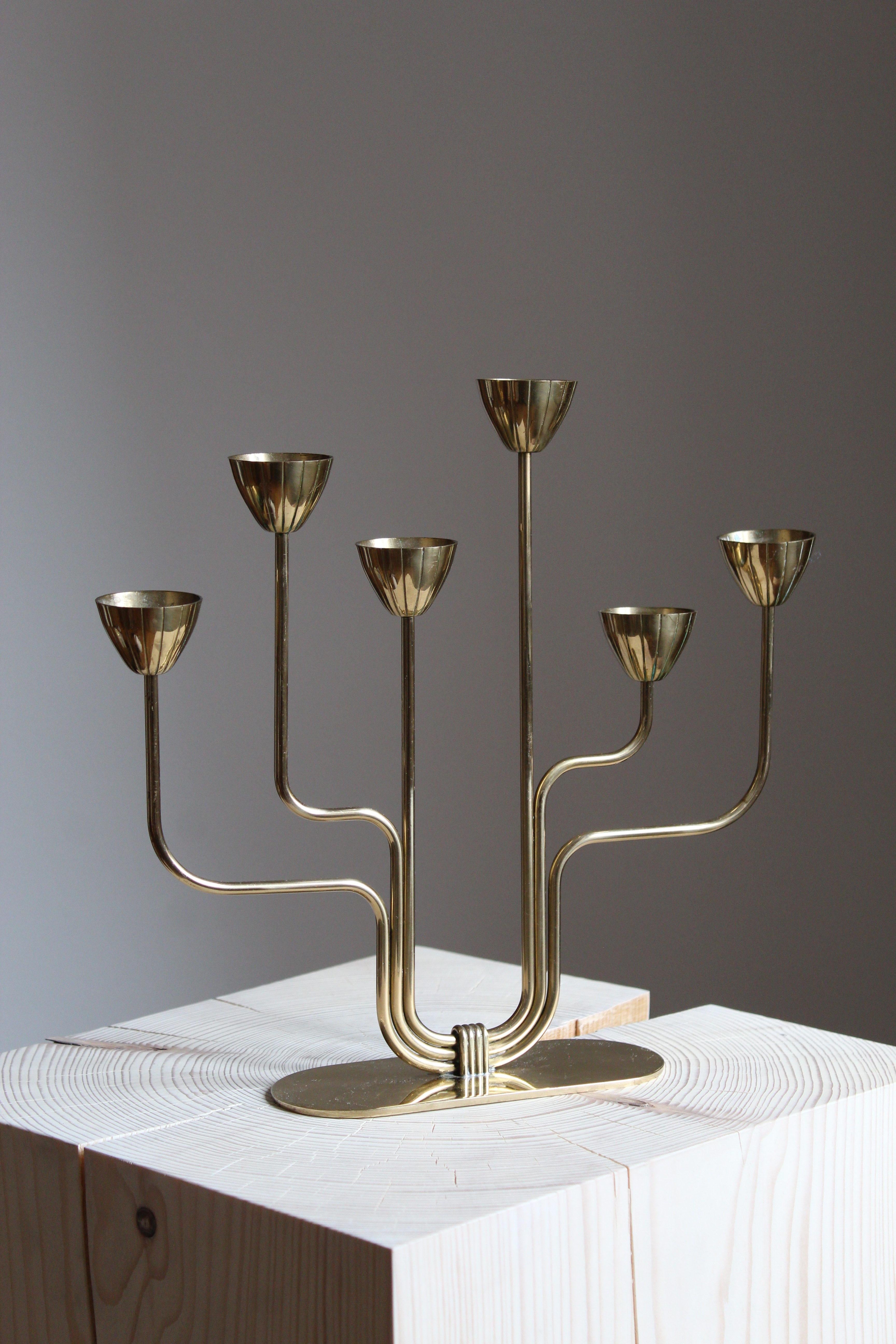 A candelabra, designed by Gunnar Ander for Ystad Metall, Sweden, 1950s. In brass and lacquered steel. Stamped. Smaller model for small candles.

Other designers of the period include Piet Hein, Paavo Tynell, Josef Frank, and Jean Royere.

  