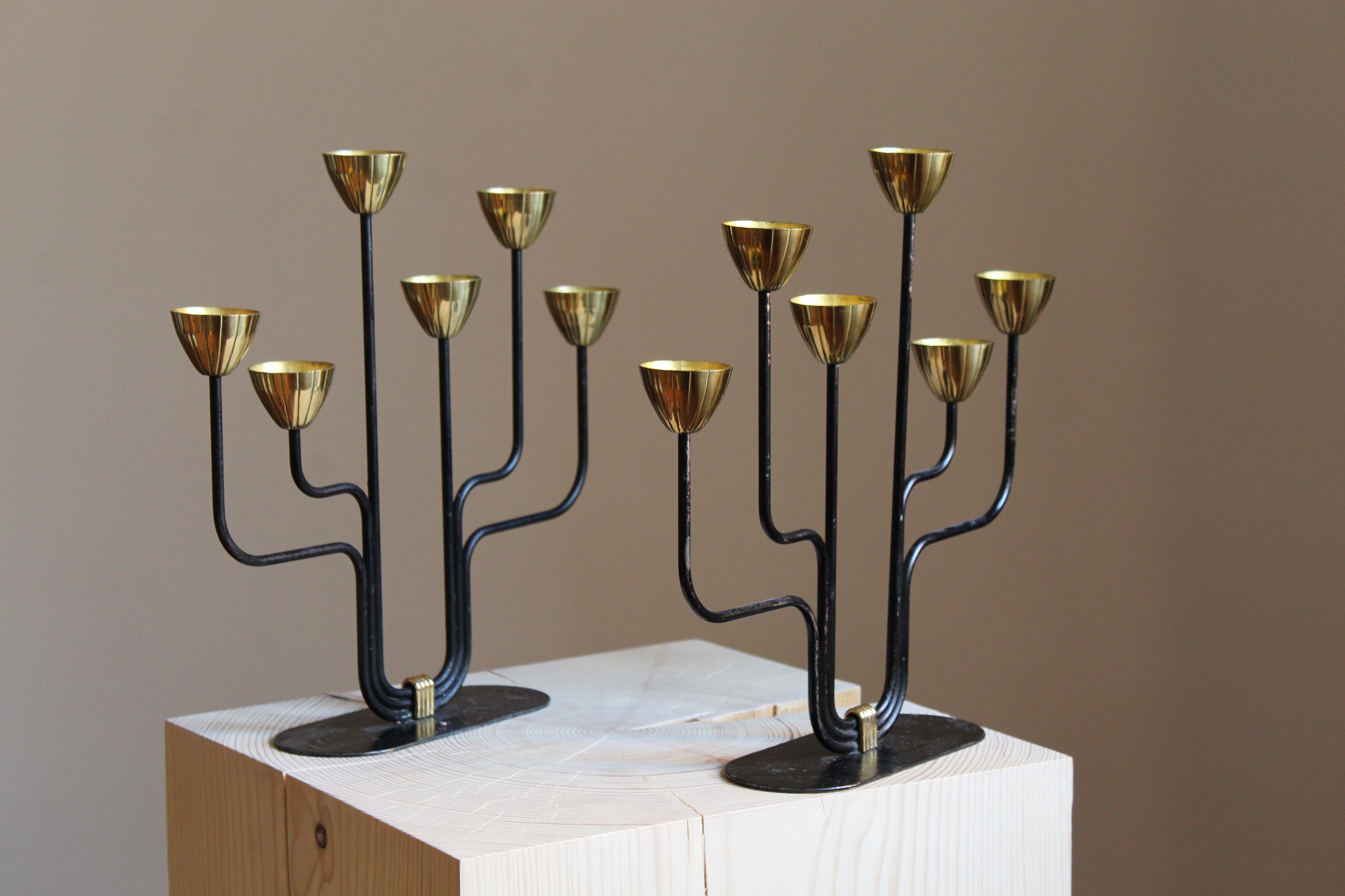 A pair of candelabras, designed by Gunnar Ander for Ystad Metall, Sweden, 1950s. In brass and lacquered steel. Stamped. Smaller model for small candles.

Other designers of the period include Piet Hein, Paavo Tynell, Josef Frank, and Jean