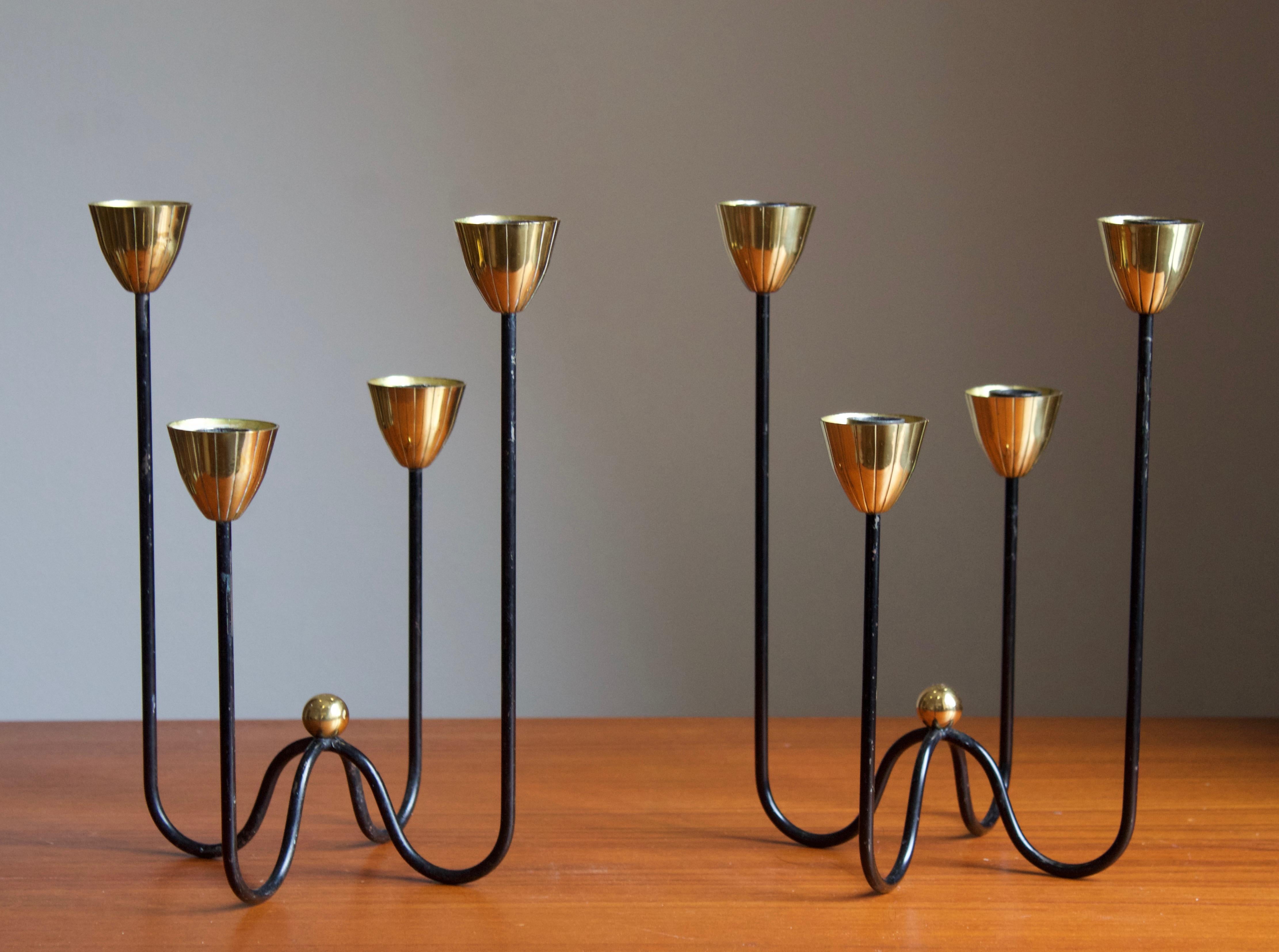 A pair of organic candelabrum or candleholders, designed by Gunnar Ander for Ystad Metall, Sweden, 1950s. In brass and lacquered steel. Stamped.

Other designers of the period include Piet Hein, Paavo Tynell, Josef Frank, and Jean Royère.

 