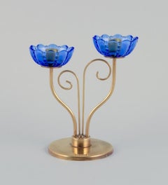 Gunnar Ander for Ystad Metall.  Brass candlestick holder with blue glass sleeves
