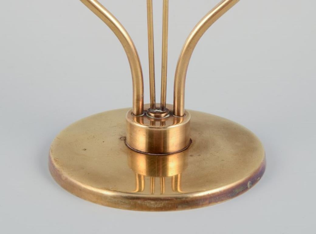 Mid-20th Century Gunnar Ander for Ystad Metall.  Brass candlestick holder with blue glass sleeves For Sale