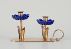 Gunnar Ander for Ystad Metall.  Candlestick holder in brass and blue art glass