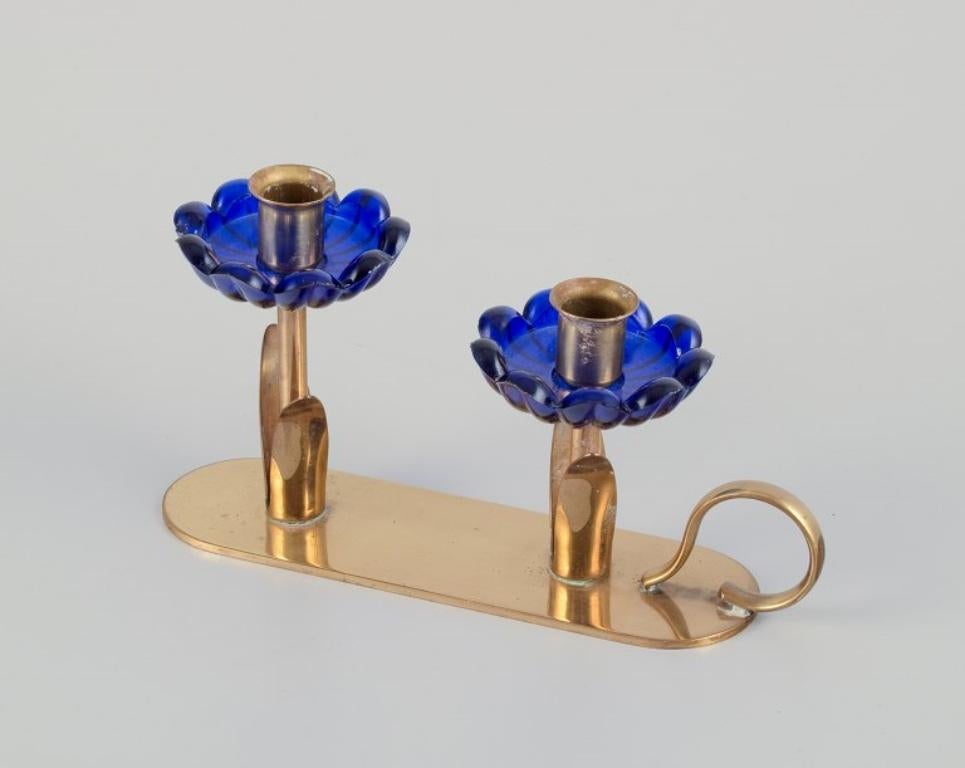 Swedish Gunnar Ander for Ystad Metall.  Candlestick holder in brass and blue art glass For Sale