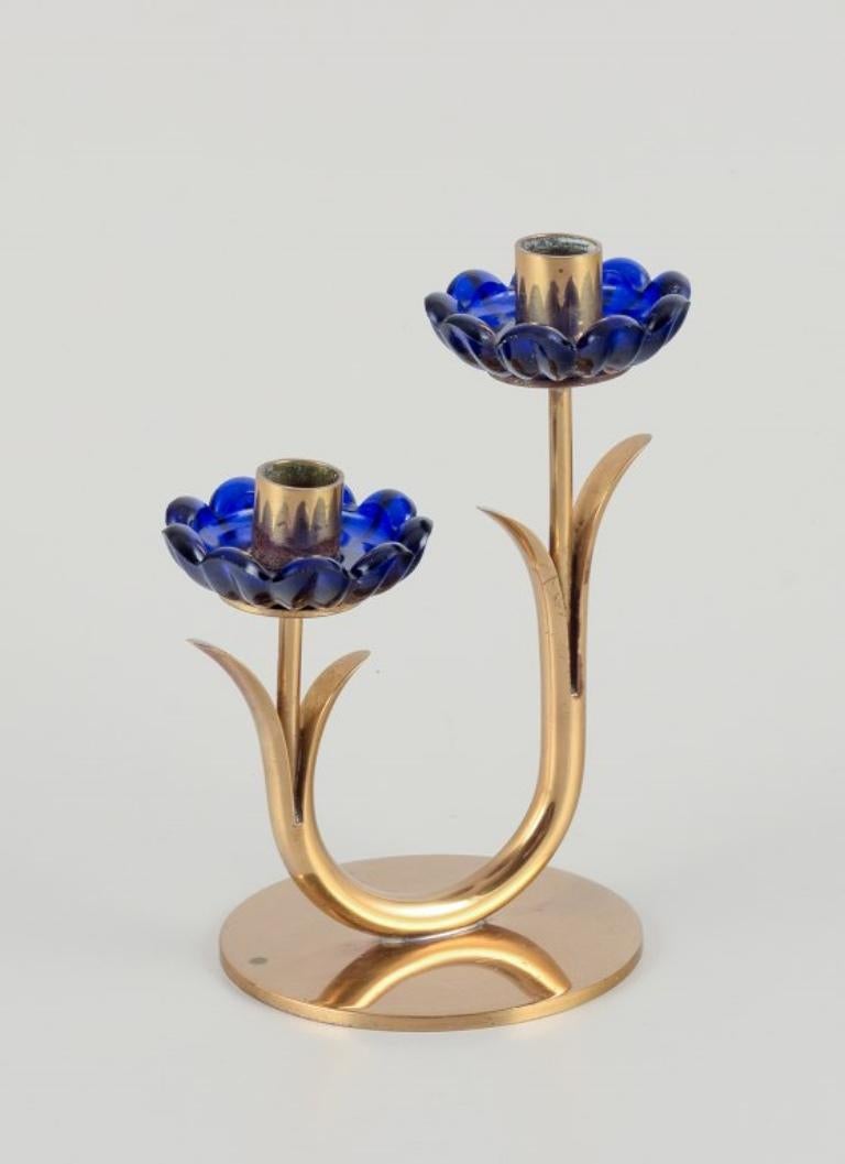 Swedish Gunnar Ander for Ystad Metall/ Candlestick holder in brass and blue art glass. For Sale