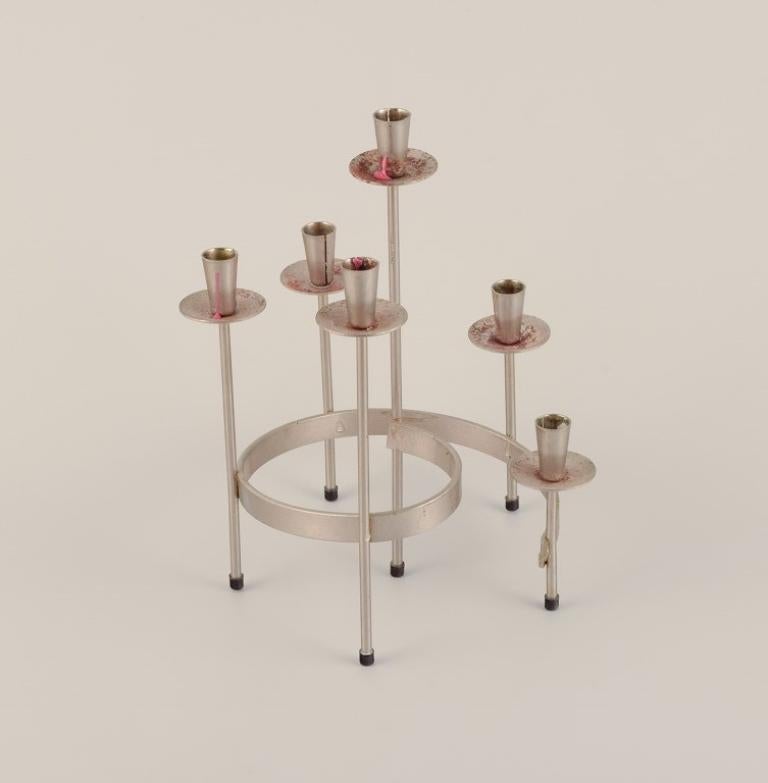 Gunnar Ander for Ystad Metall, Sweden. 
A pair of candle holders in silver-plated brass. For six candles.
Modernist design.
Approximately 1970.
In very good condition with rust on the light cuffs.
Dimensions: D 19.0 cm x H 24.0 cm.