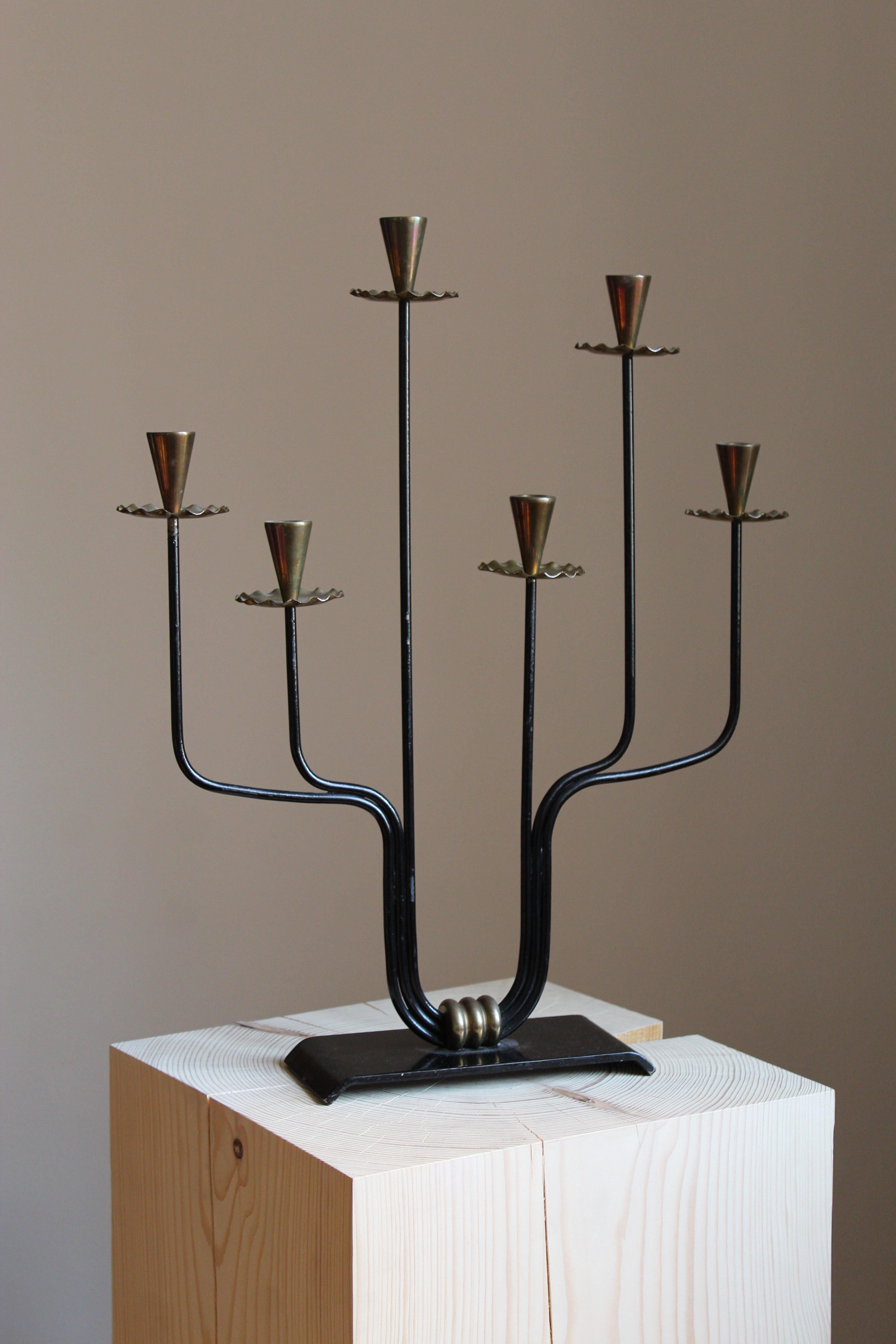 A candelabra, attributed to Gunnar Ander for Ystad Metall, Sweden, 1950s. In brass and lacquered steel. 

Other designers of the period include Piet Hein, Paavo Tynell, Josef Frank, and Jean Royere.

 
