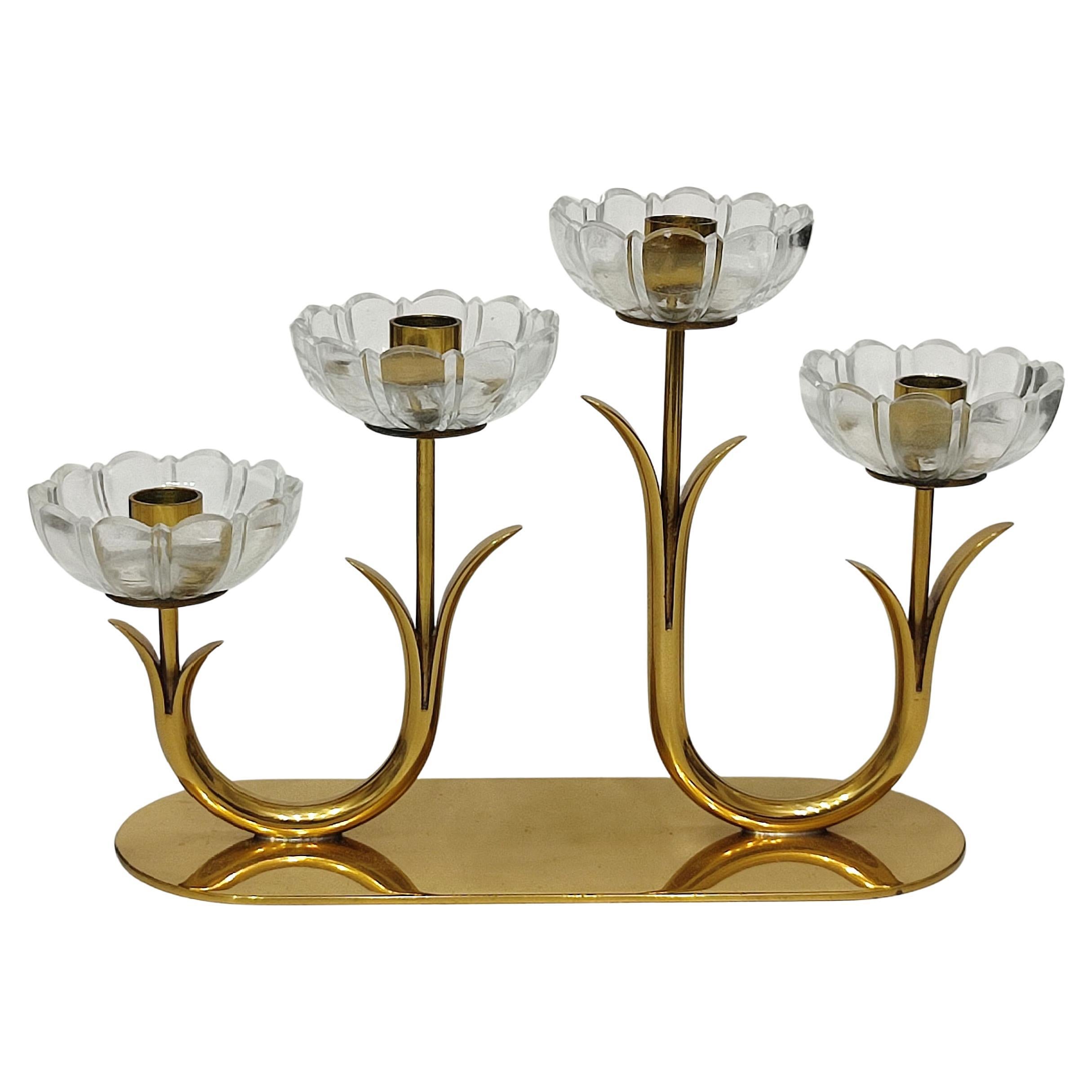 This elegant pair of floral candle holders was designed by Gunnar Ander for Ystad Metall, a Swedish metalworks company renowned for its refined decorative objects during the mid-20th century. 
For candles of ~1 cm (0.45”) diameter.
Measures: 21 x