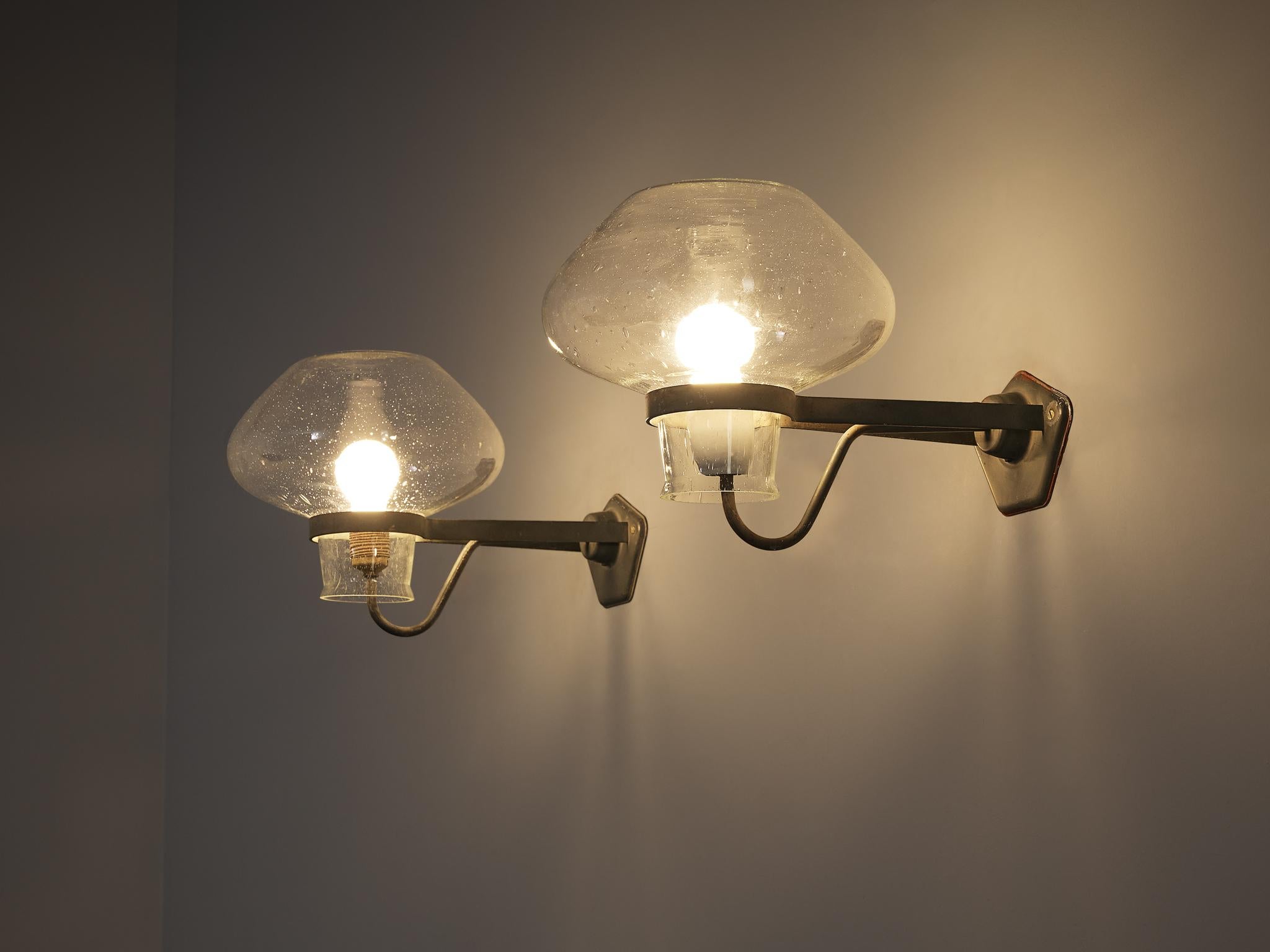 Gunnar Asplund for ASEA, wall lamps, model '641', blown glass, lacquered metal, Sweden, 1940s

Swedish architect Gunnar Asplund (1885–1940) designed this elegant wall lamp, model 641, in the 1940s. This striking fixture features a polygonal
