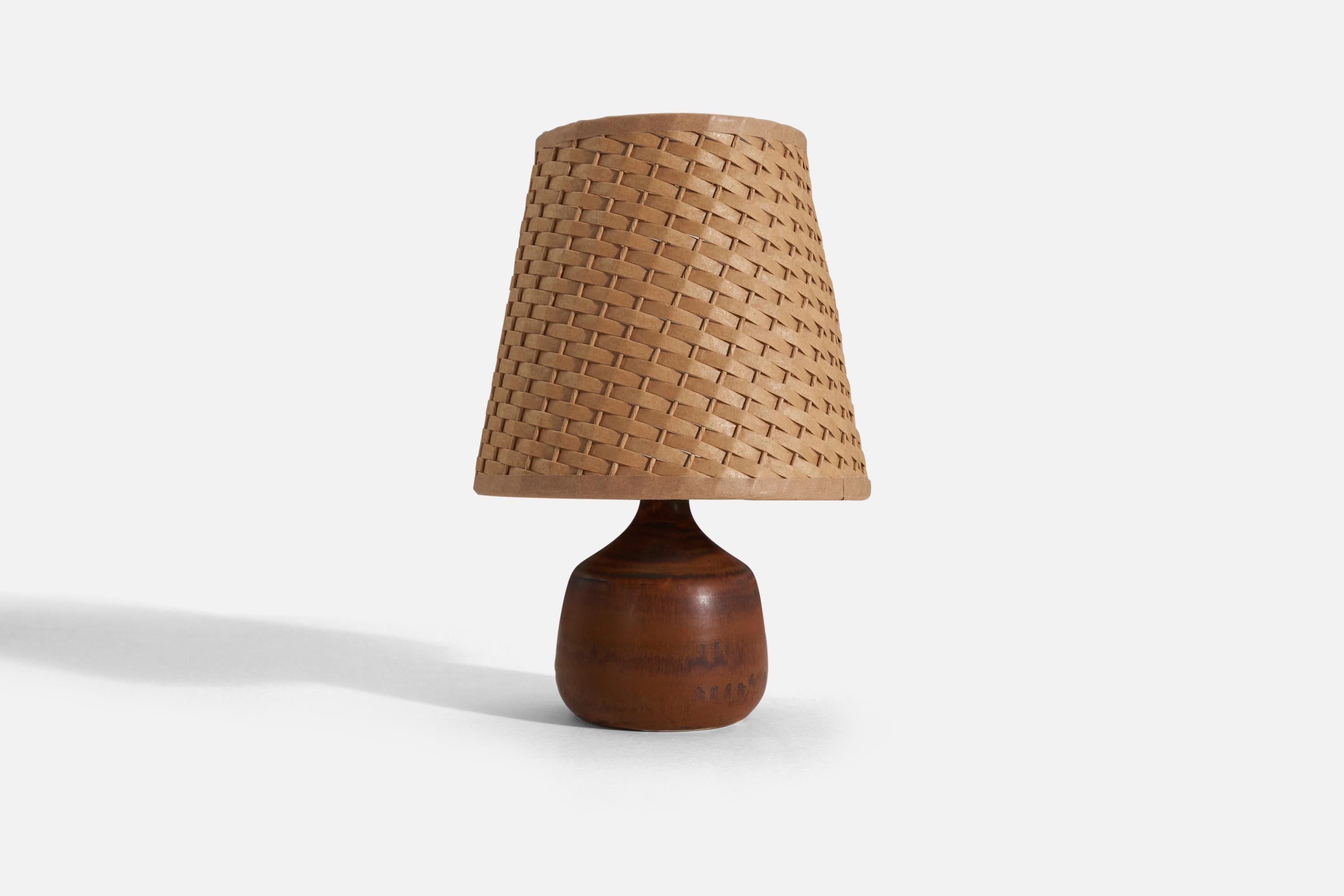 A brown-glazed stoneware table lamp designed by Gunnar Borg for Höganäs, Sweden, 1960s. 

Stated dimensions exclude lampshade, upon request illustrated lampshade can be included in purchase.
For reference:
Dimensions of shade : 4.25 x 6 x 5.75