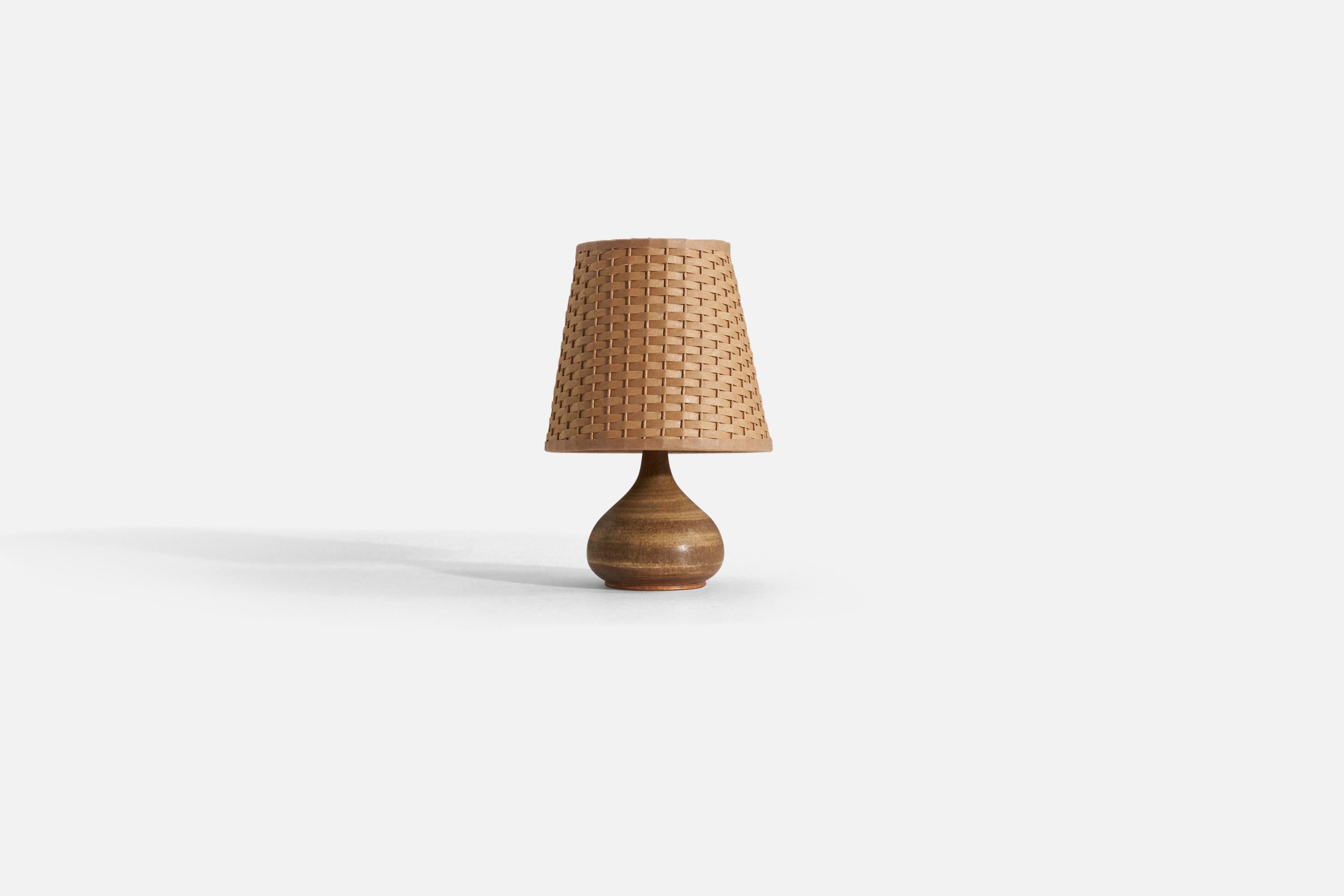 A brown-glazed stoneware table lamp designed by Gunnar Borg for Höganäs, Sweden, 1960s.

Stated dimensions exclude lampshade, upon request illustrated lampshade can be included in purchase.

Measurements listed are of lamp.
Shade : 4.25 x 6.25