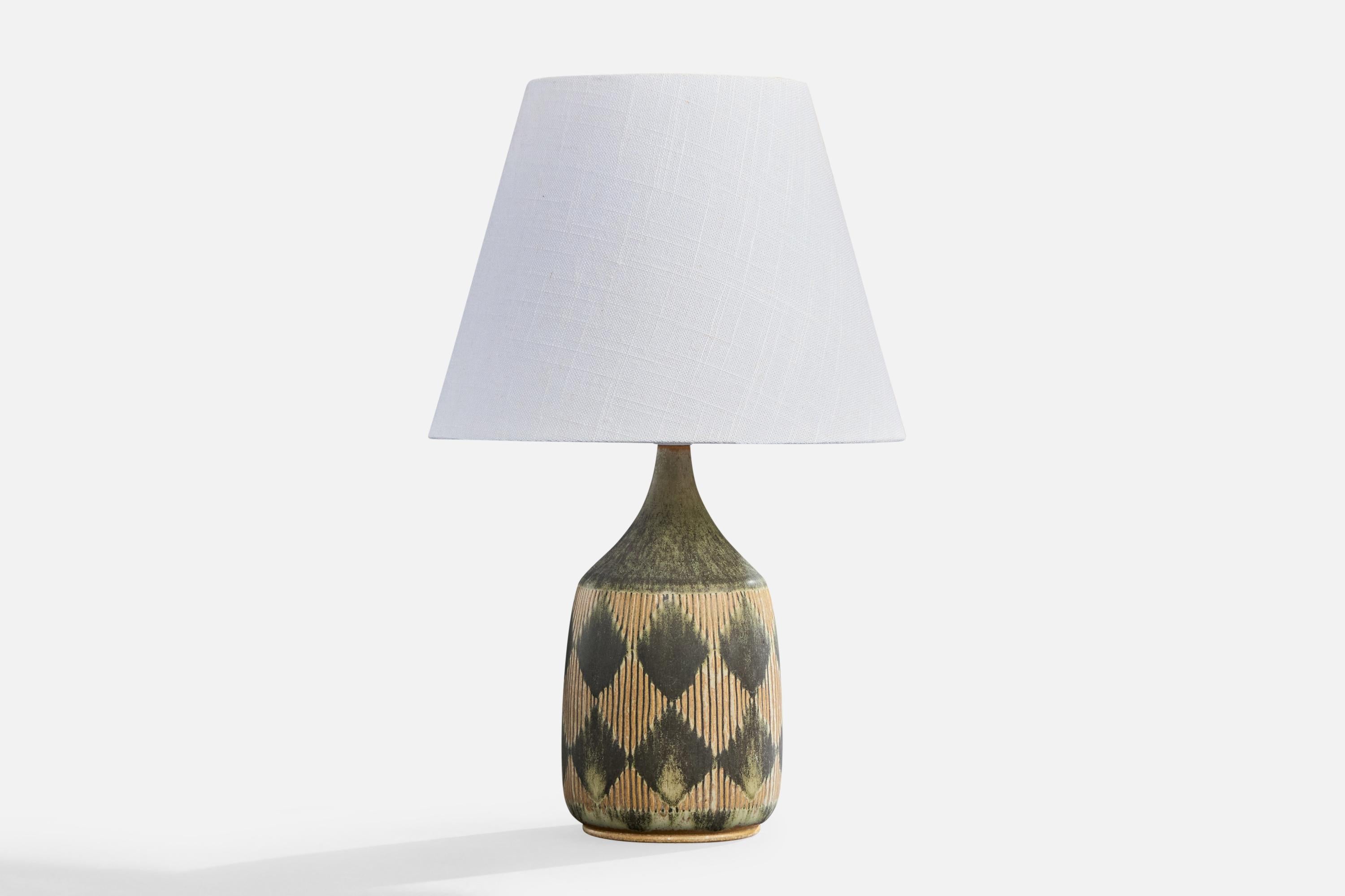 A green and beige-glazed incised stoneware table lamp designed and produced by Gunnar Borg, Höganäs, Sweden, c. 1960s.

Dimensions of Lamp (inches): 10.375