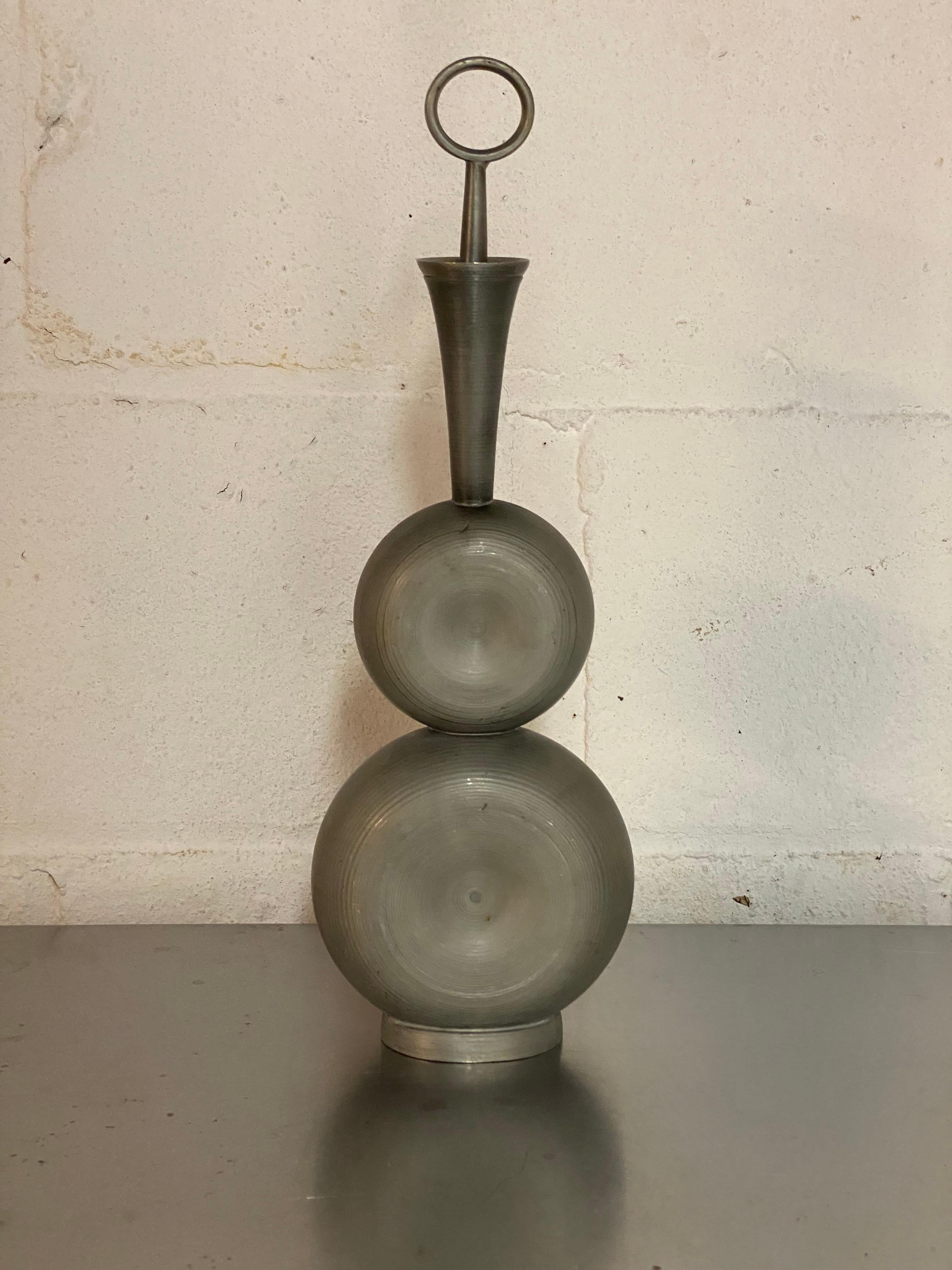 A wonderfully graceful pewter decanter with stopper by Norwegian metalsmith, Gunnar Havstad. The beauty of this piece, aside from the tiered and tapered design, is the retaining of the Mid Century Modern design with Scandinavian Folk Art aesthetic. 