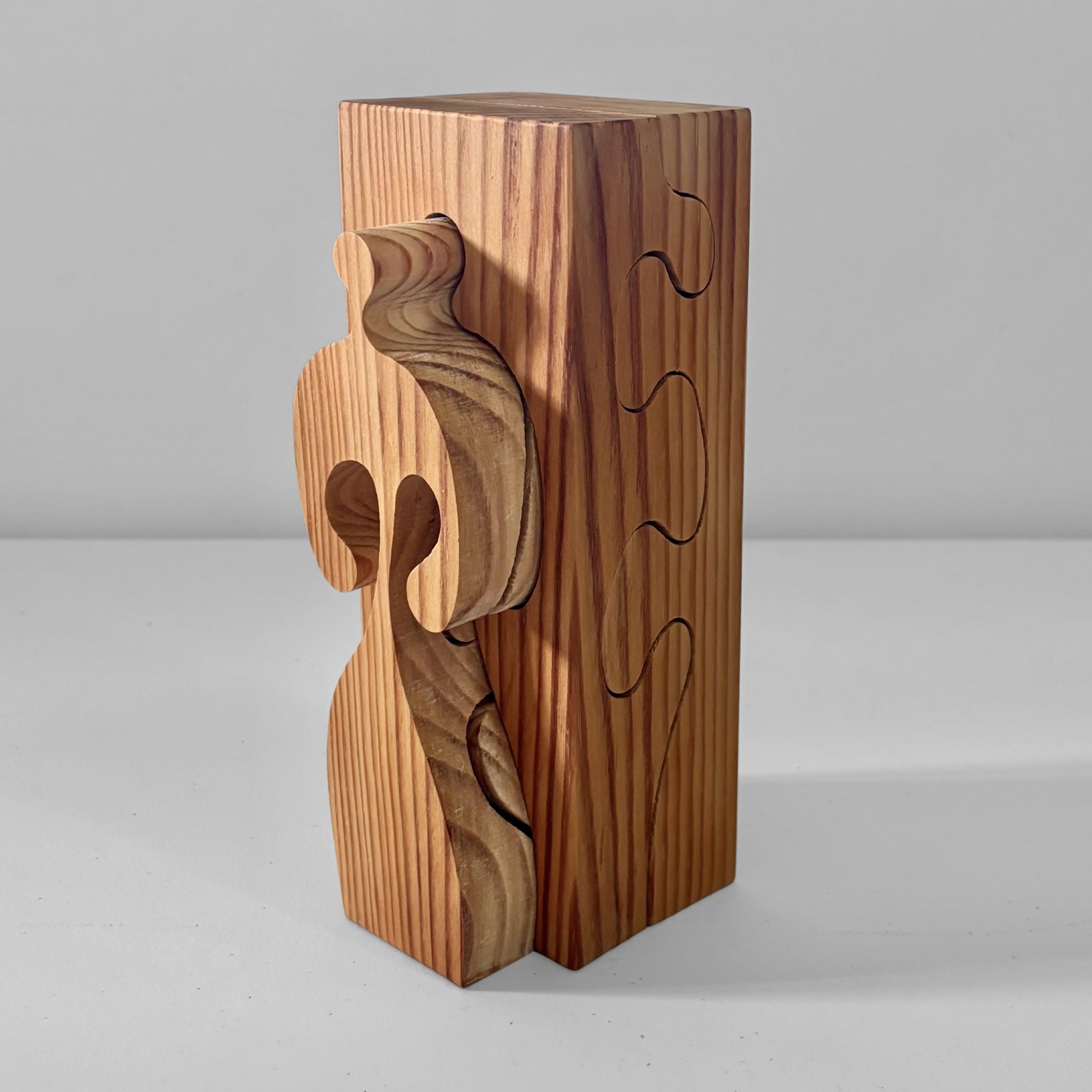 A decorative sculpture in the form of a wooden puzzle, crafted from solid pine by Swedish artist Gunnar Kanevad (1930–2019). It features two human silhouettes sawn from a pinewood cuboid. Marked with the artist’s name and studio underneath.

Swedish
