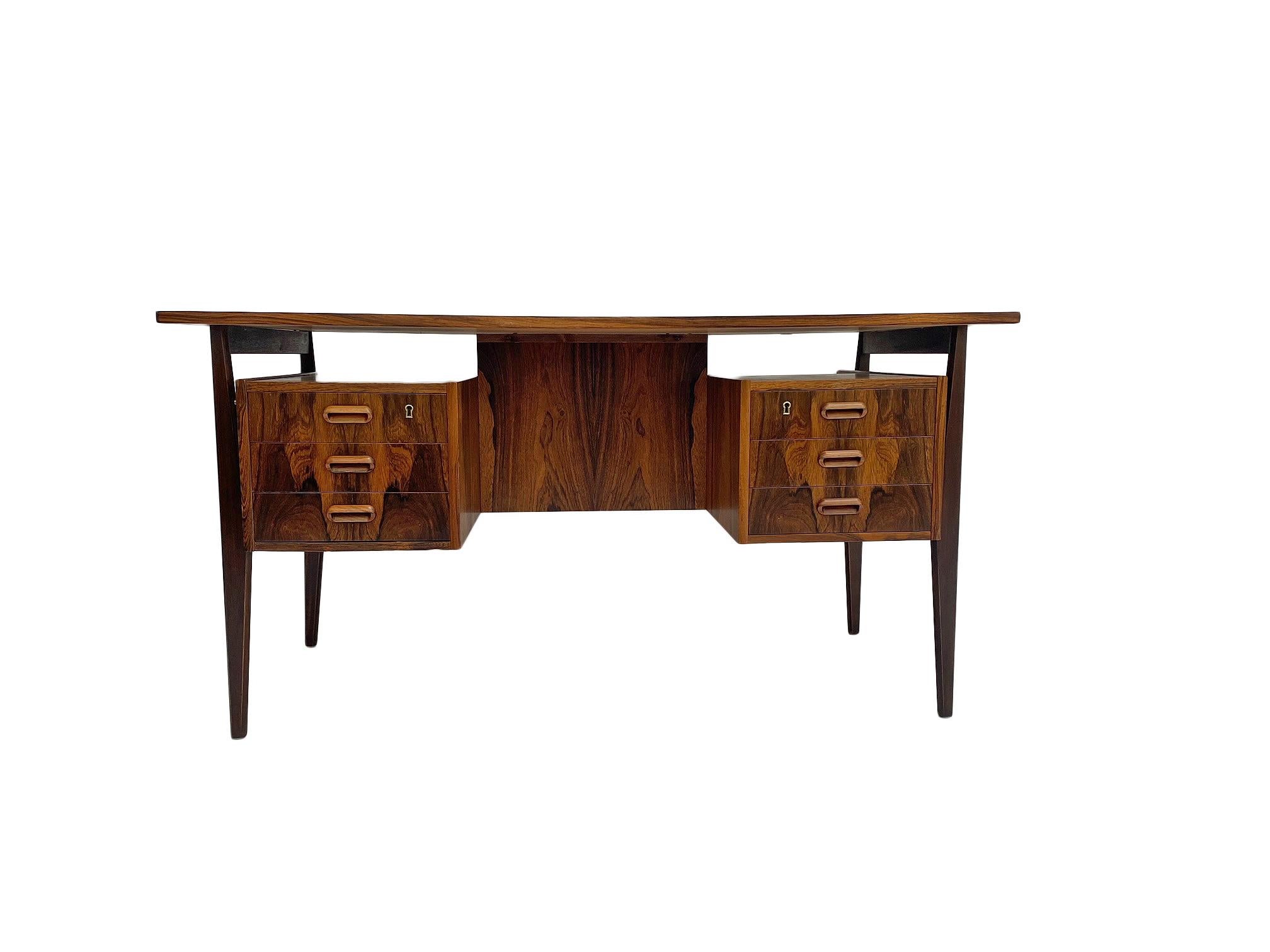 Designed by Gunnar Nielsen for Tibergaard in 1960's Denmark, this exquisite writing desk would make a stylish addition to any home or office environment. 

This writing desk boasts Nielsen's flair for style, form and functionality with no detail