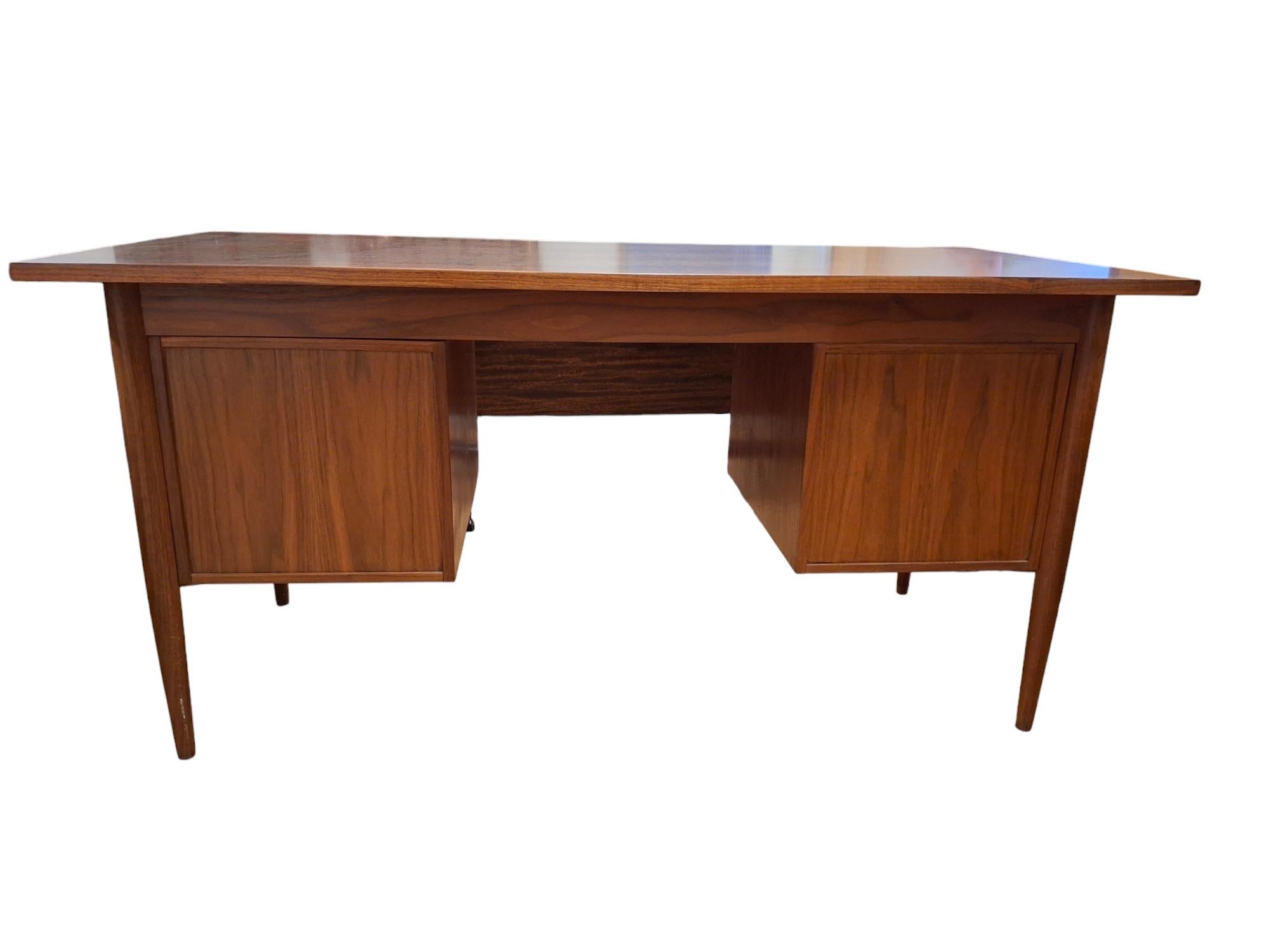 Danish Modern Gunnar Nielsen Tibergaard teak desk, having a rectangular top, above the four drawer case and rising on tapered legs.  Desk top has been beautifully refinished.  Original key included.