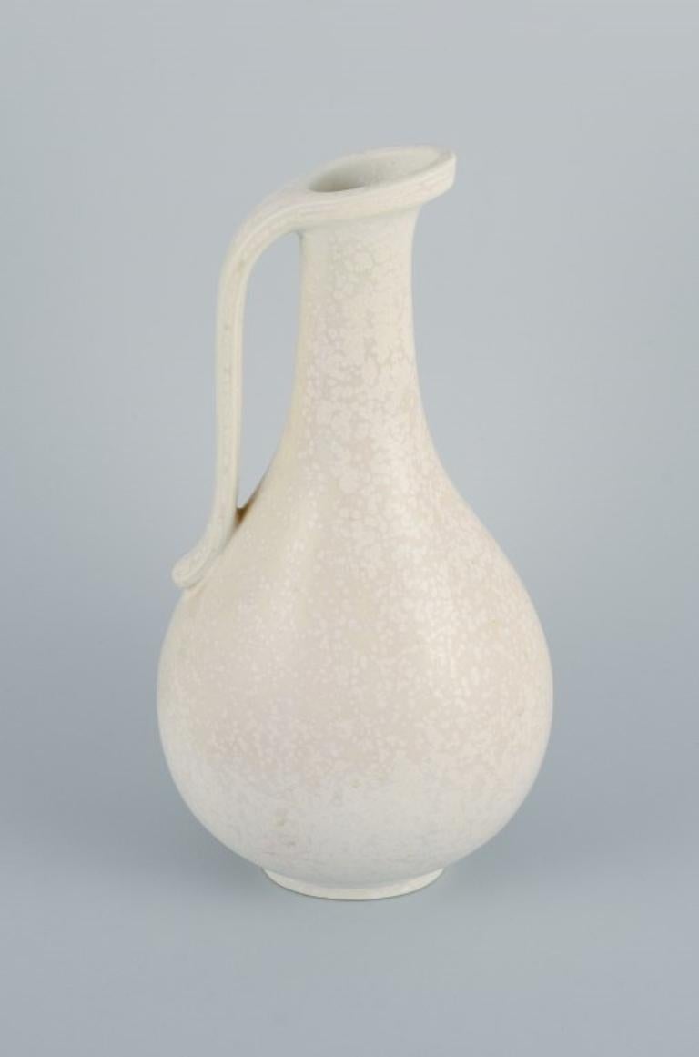 Gunnar Nylund (1904–1997) for Rörstrand. Large jug in eggshell glaze.
Mid-20th century.
In perfect condition.
Marked.
Dimensions: H 24.5 x W 11.0 cm.