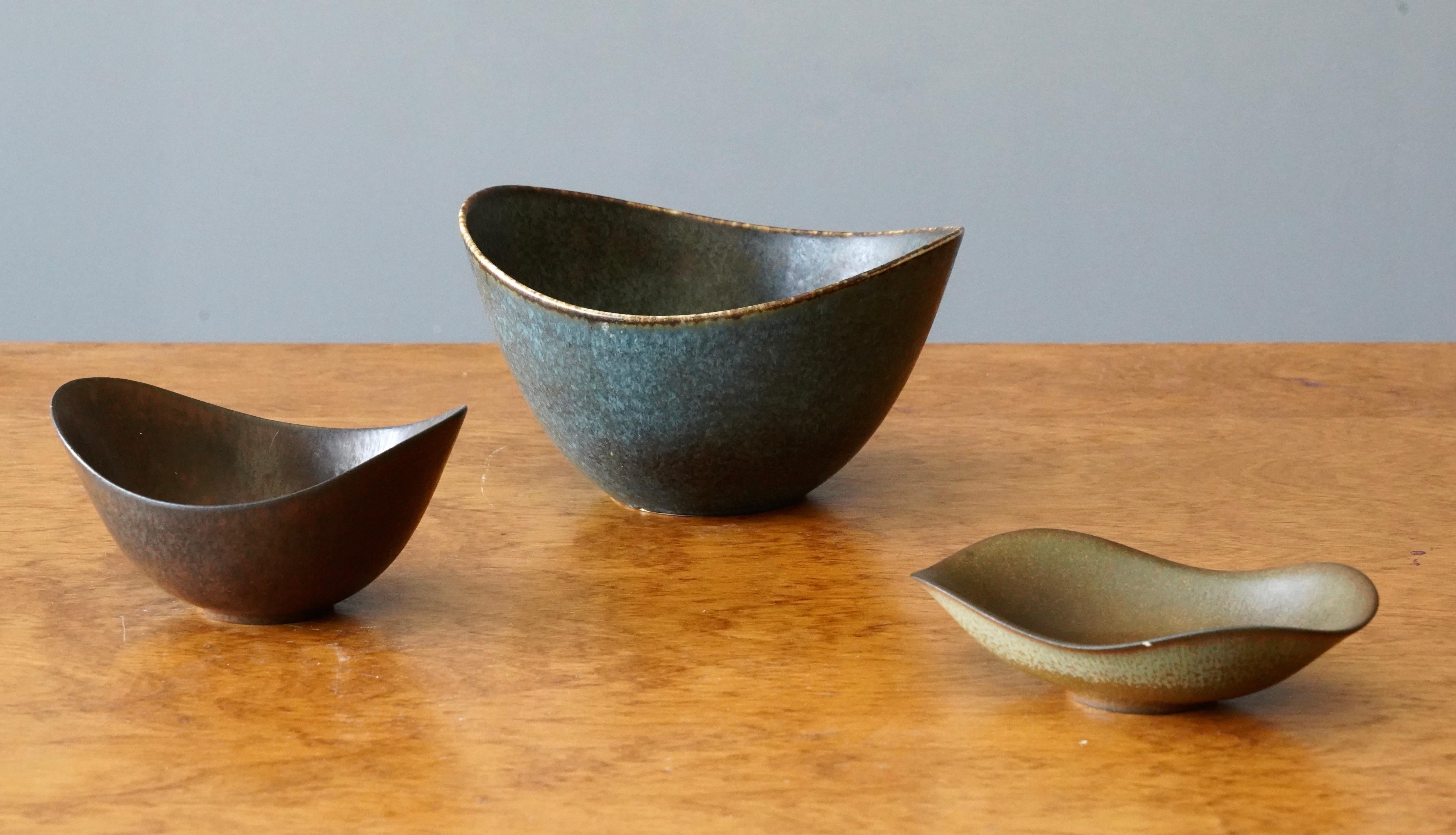 A set of three bowls produced by Rörstrands, Sweden, 1950s. Designed by Gunnar Nylund, (Swedish, 1914-1997). Signed. 

Listed height is of larger bowl. Medium sized bowl is 5