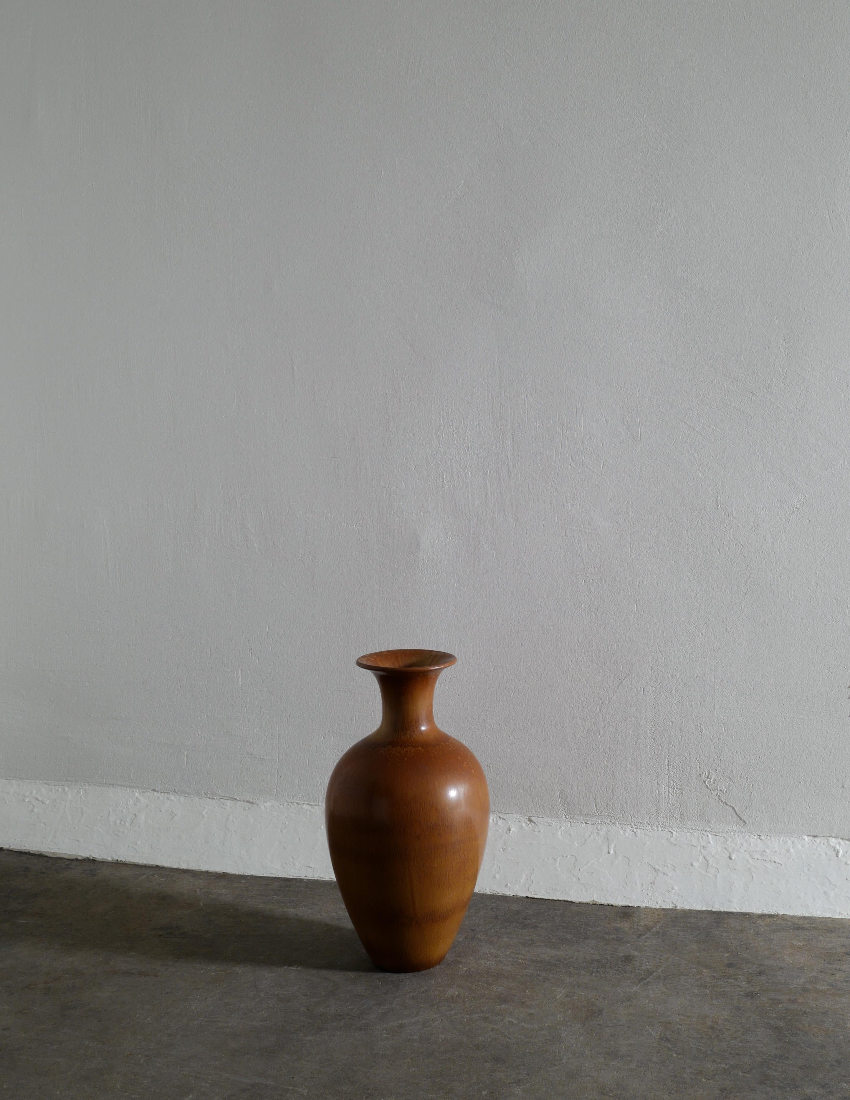 Rare mid century floor vase in a brown glaze designed and made by Gunnar Nylund for Rörstrand Sweden in the 1950s. In good vintage condition with small signs from age and use. Signed 
